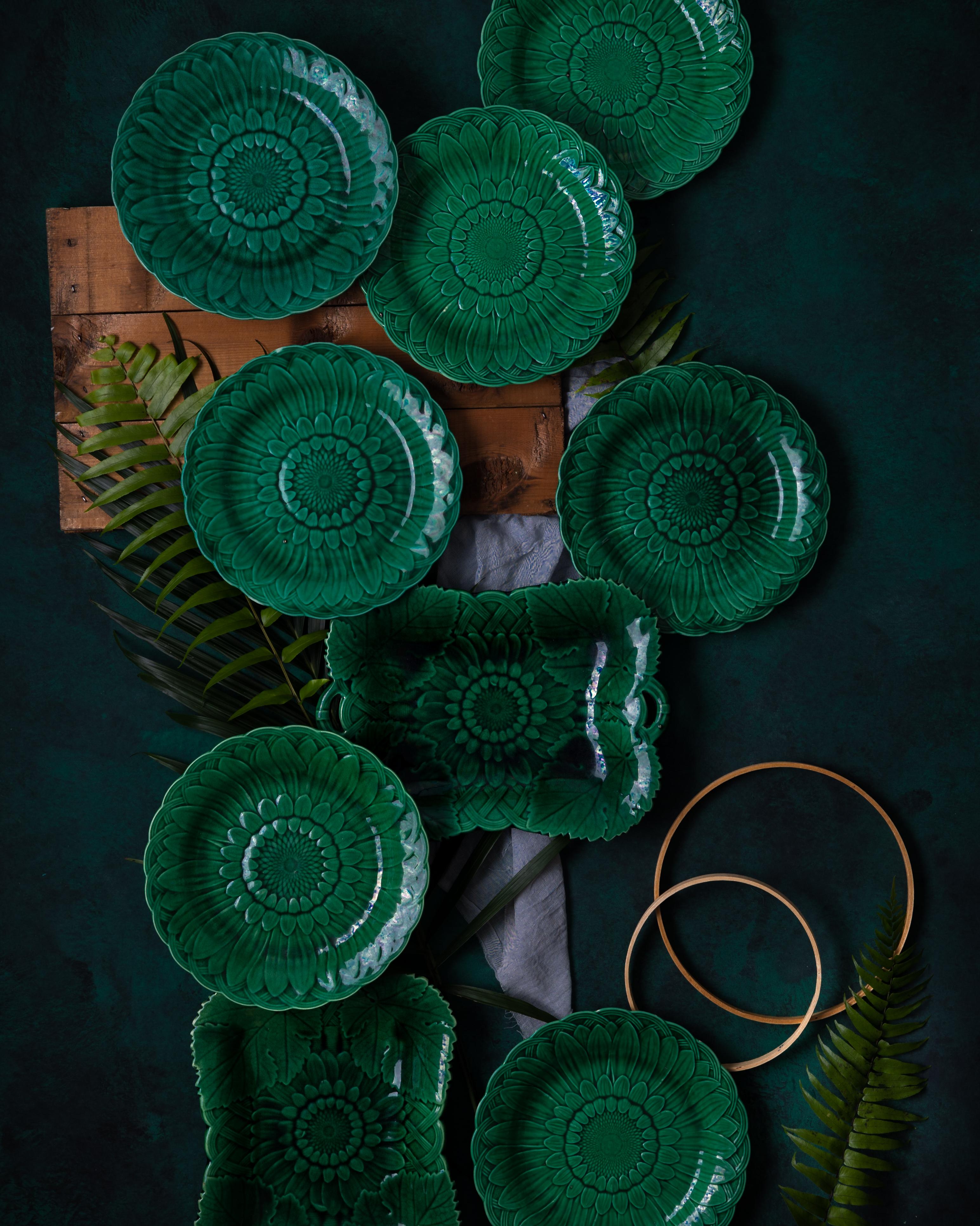 Set of 20 green majolica glazed dinner plates in the ‘Sunflower’ pattern by Wedgwood, made circa 1880.

The sunflower, alongside the calla lily and peacock feather, became an emblem of the late nineteenth-century Aesthetic Movement. Oscar Wilde