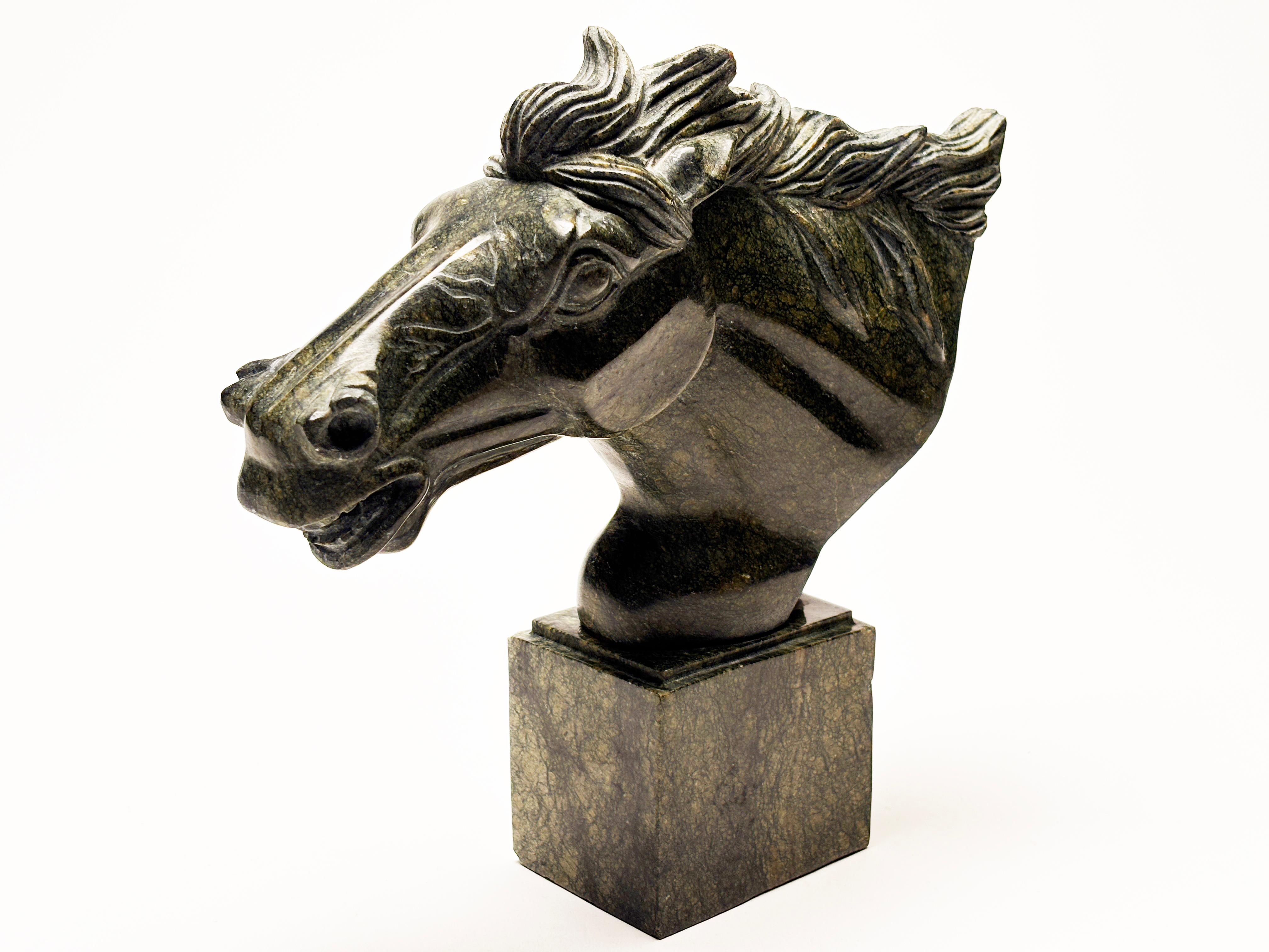 This sophisticated and stoic horse head sculpture, in unique green marble boasting hints of mustard and veins of dark green, illuminates the amazing creative skills that went into this carving. This lovely sculpture showcases Greek influence in the