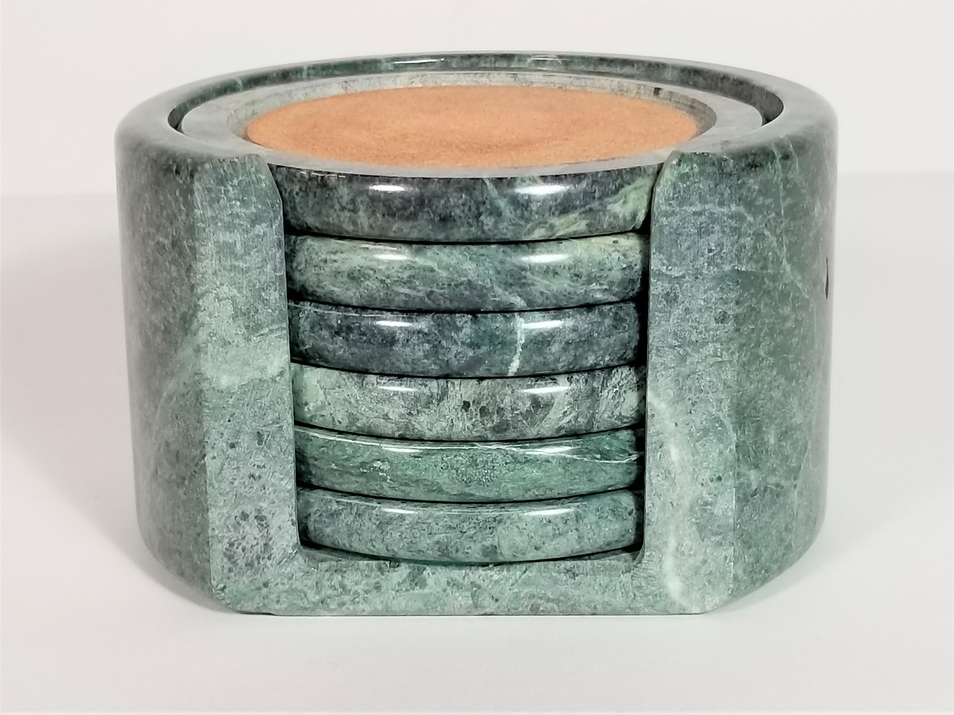 1980s midcentury green marble coasters. 7 piece set includes 6 coasters and 1 marble holder. Green Felt on bottom of all coasters and holder to protect surface.
Excellent condition
Measurements:
Holder height 3.0 inches
Holder diameter 4.75