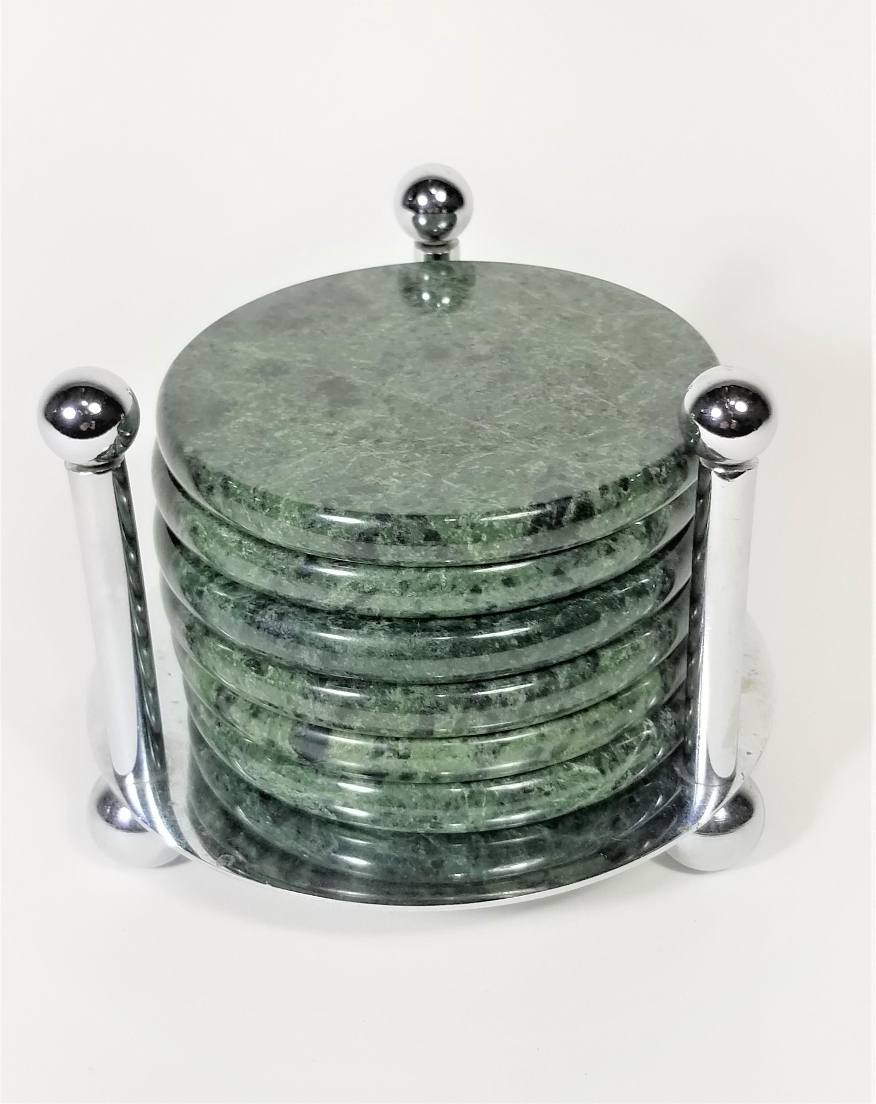 Mid-Century Modern 1970s-1980s green marble coasters with chrome holder. Protective cork on bottom of coasters. Set of 6 coasters.

Measurements:
Coaster height: 0.5 inches
Coaster diameter: 4.0 inches

Holder height: 4.0 inches
Holder