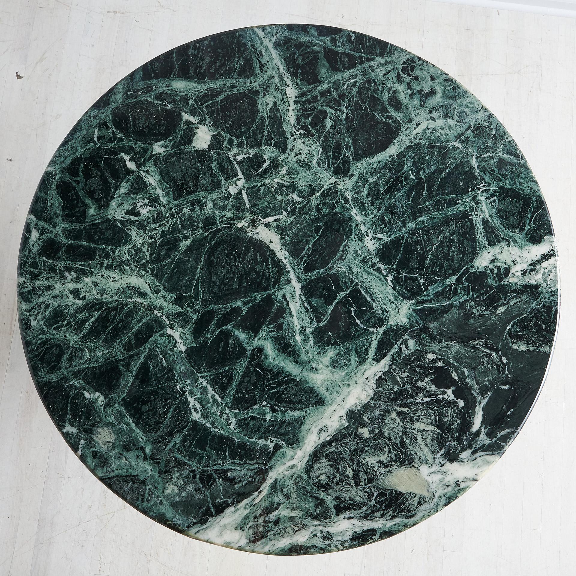 A vintage dining table sourced in Europe featuring a beautiful green Guatemalan marble with gorgeous veining and lots of movement.