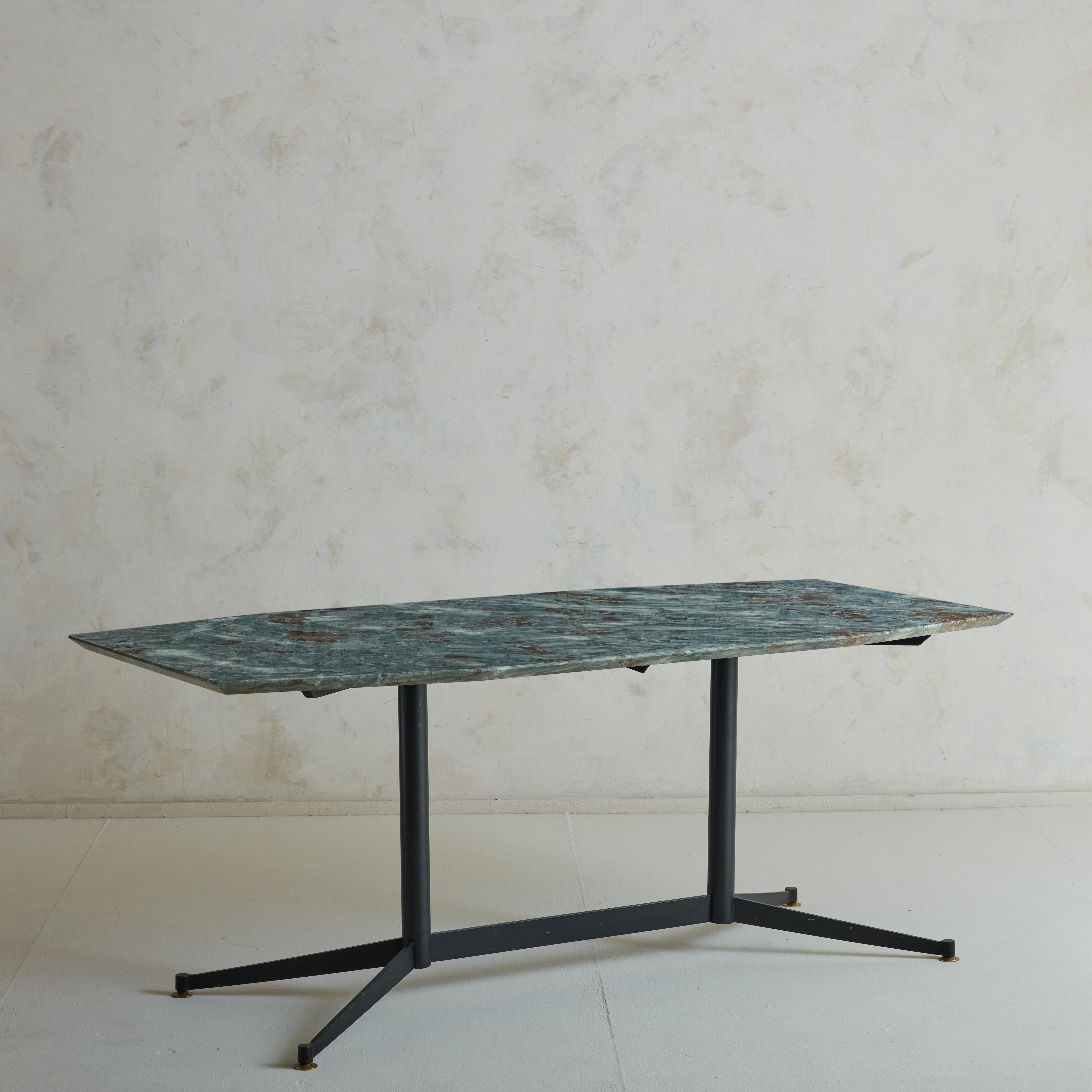 A Mid-Century modern dining table featuring  Green Octagonal Marble Top with Beveled Edge, and black steel trastle legs with brass feet details. In the style of Ignazio Gardella.

Ignazio Gardella is an Italian architect, engineer and designer who