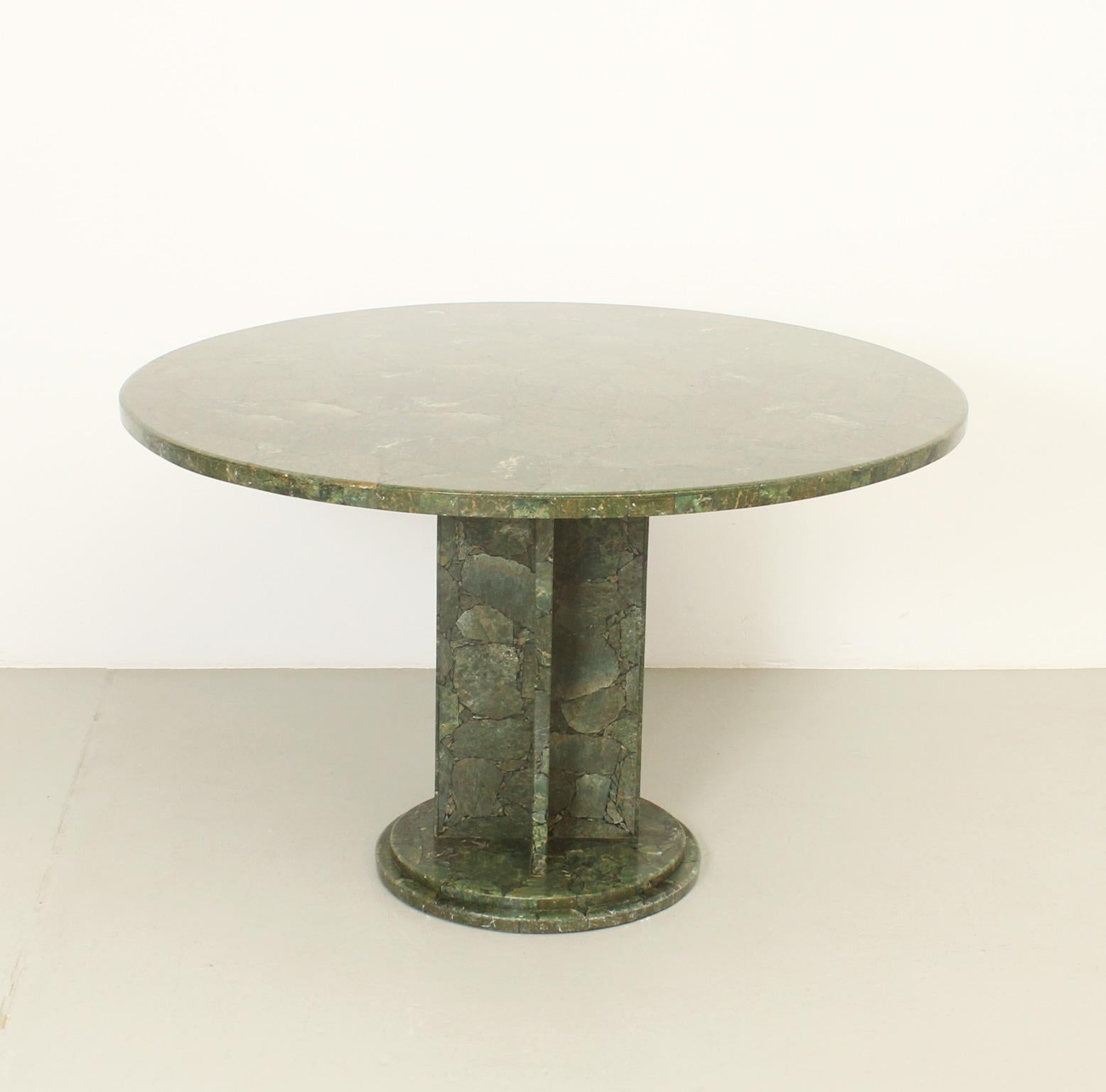 Dining table in green marble from 1970s. Made with pieces of green marble mosaic and black polished resin obtaining a very interesting effect.
