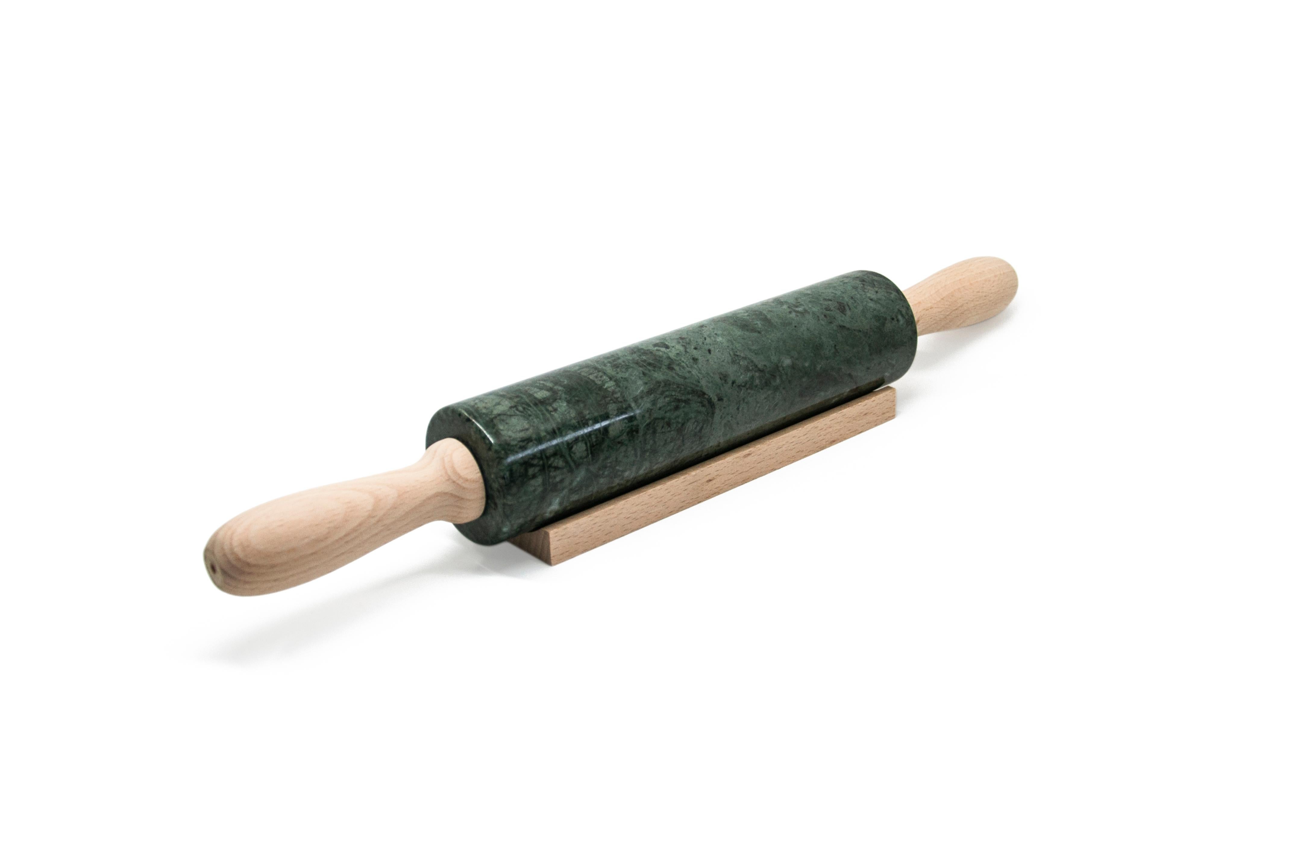 Green Guatemala marble rolling pin with wooden handles. It is assembled manually. Each piece is in a way unique (every marble block is different in veins and shades) and handmade by Italian artisans specialized over generations in processing marble.