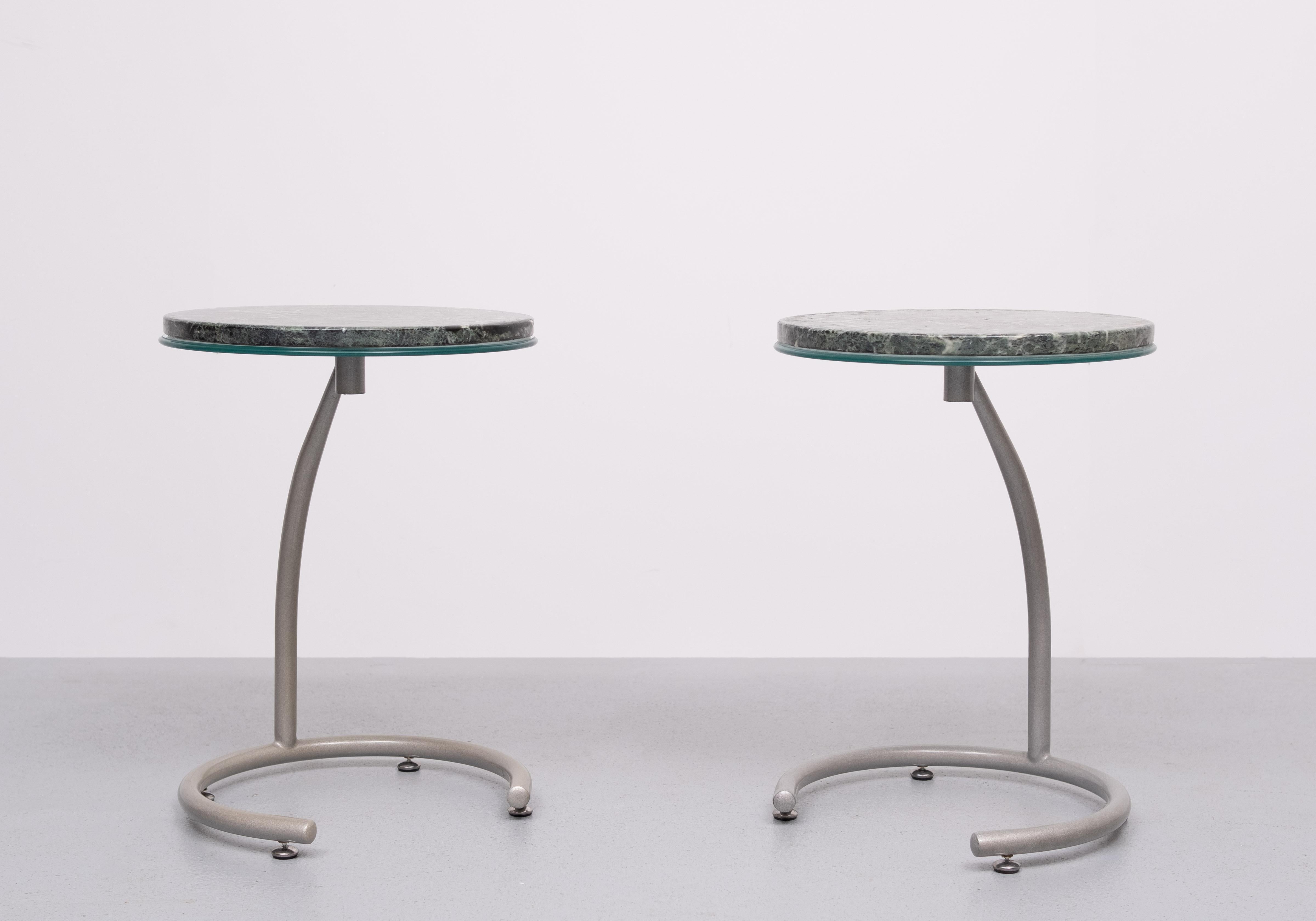 Very nice set of side tables .Curved Grey Metal frame ,comes 
with a round Glass and on top of that a Green Marble tops . 
Good condition.