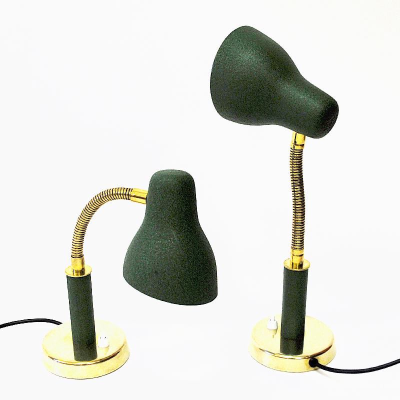 Lovely green and brass midcentury pair of metal table -or wall lamps from Nordiska Kompaniet (NK) Sweden 1950s. Model: NK 32535. Cone shaped shades with inner white painting. Brass stem which are adjustable in all directions and a green handle