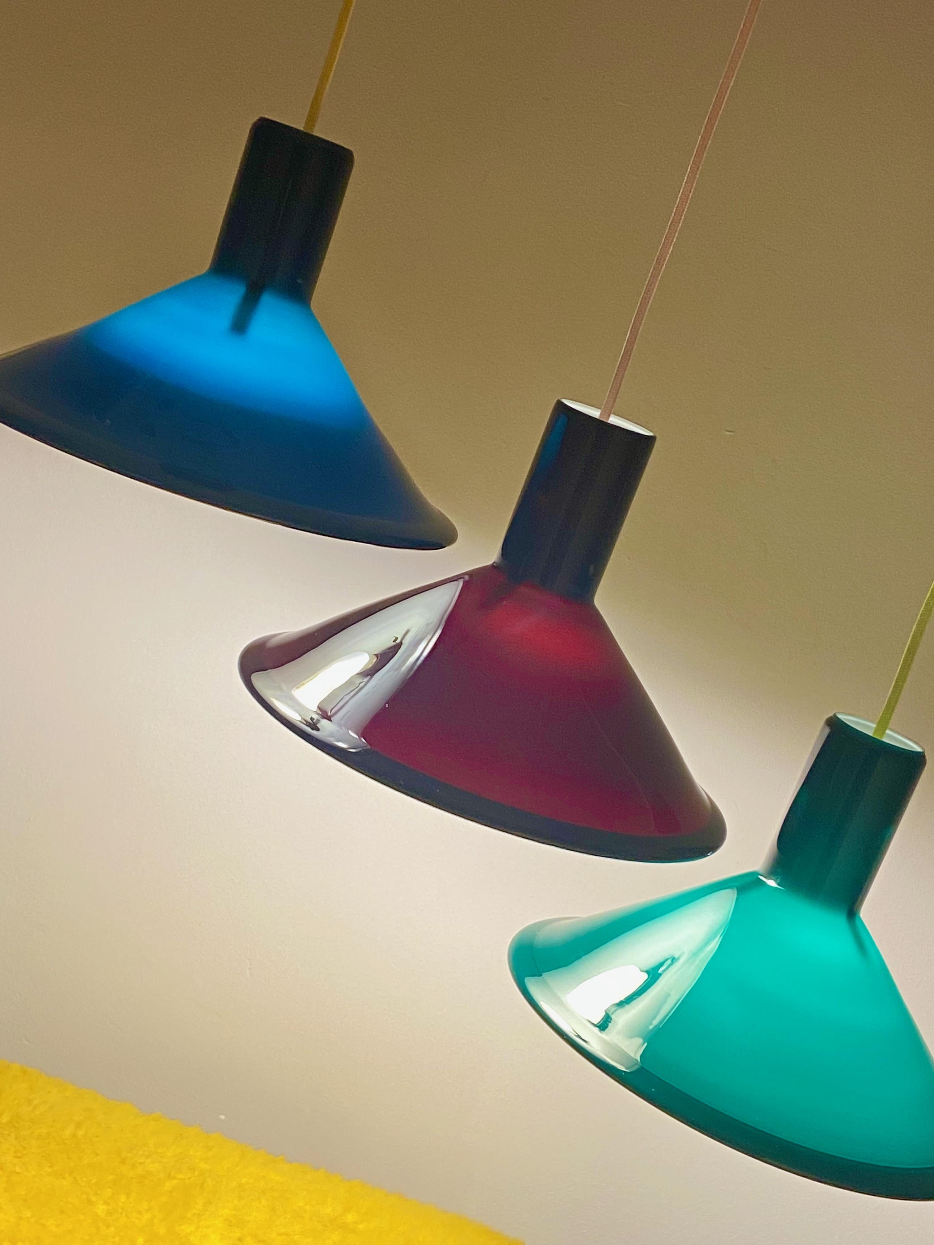 P&T pendant lamp designed by Michael Bang for Holmegaard in the 1970s. This Danish lamp is made of opaline glass and is dark green on the outside and white on the inside. The lamp is in very good condition, no damages and comes with neon yellow