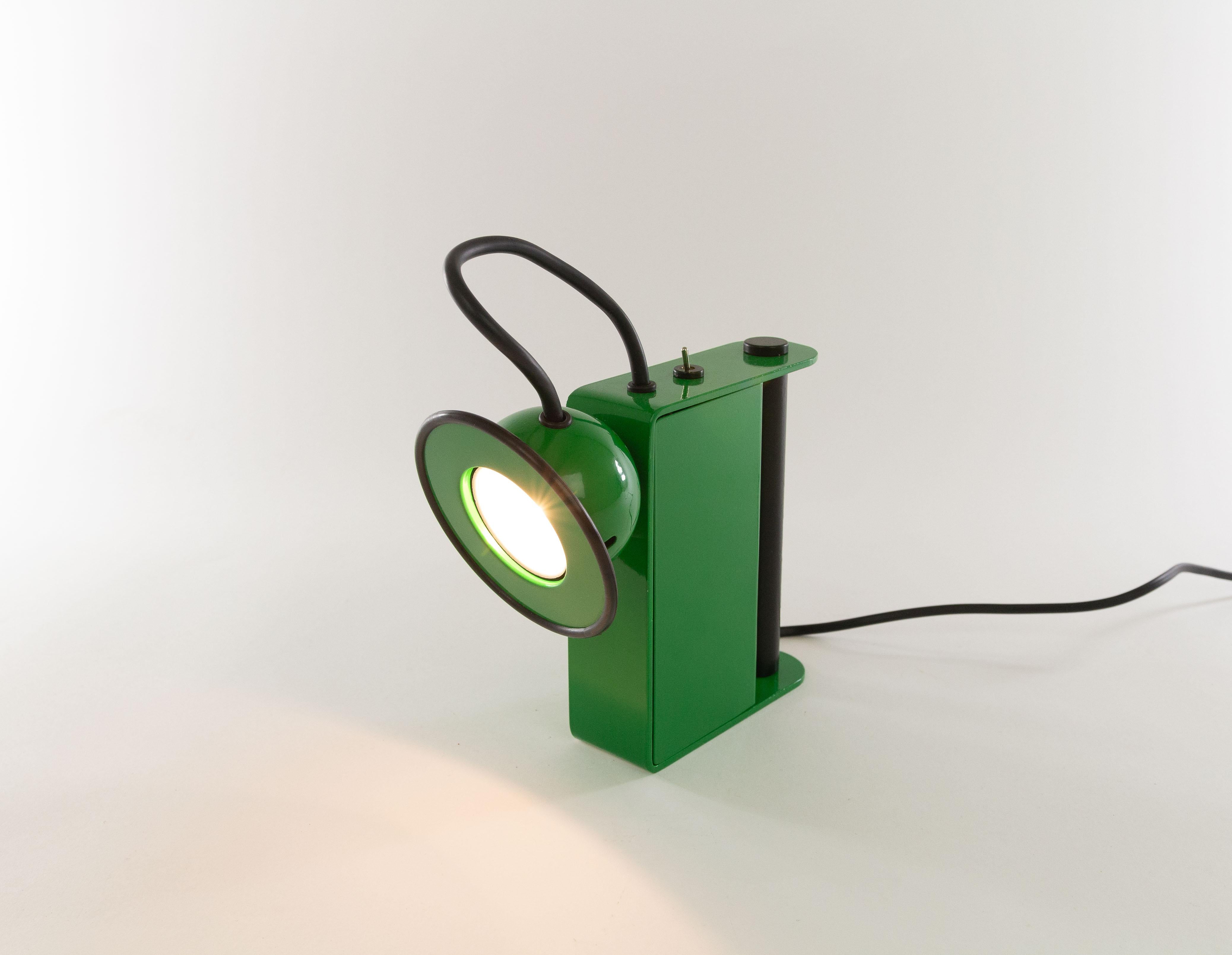 Green Minibox table lamp designed by Gae Aulenti & Piero Castiglioni and manufactured by Stilnovo in 1980.

This halogen table lamp can also be used as a 'torch' thanks to the handy handle. However, due to the power cord, it can only be used