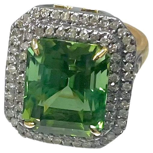 Description
The vibrant green of this Asscher cut Mint Tourmaline with its subtle blue center core gives the stone a rare multi-dimensional effect. The stone is framed with a double step row of pave diamonds. Item #R132

Materials and Weight
Mint