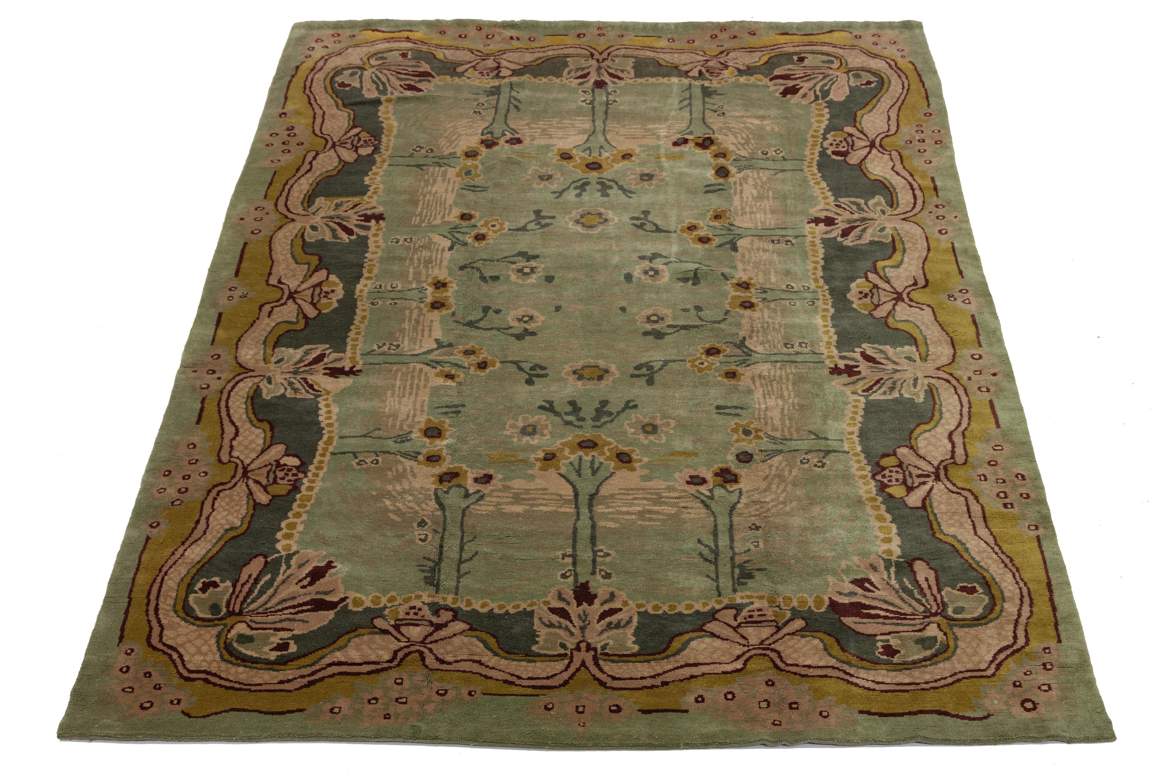 Beautiful modern Art & Crafts-style hand-knotted wool rug featuring a green color field. This Persian rug has a designed frame with goldenrod, peach, and burgundy accents in an all-over floral design.


This rug measures: 12'3