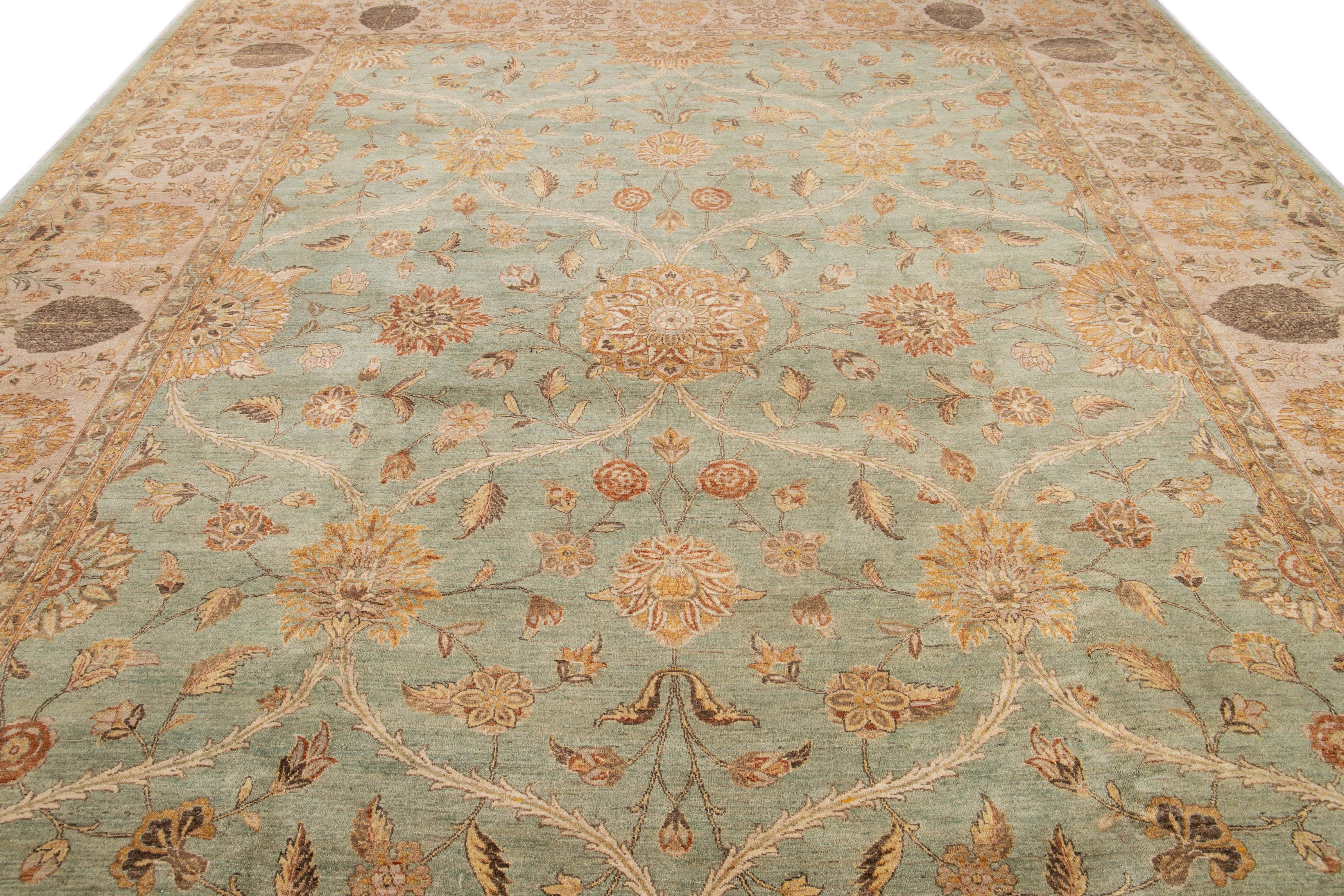 This Tabriz-style wool rug boasts a splendidly intricate floral design, classically presented in a green color field, featuring golden, beige, and brown accents.

This rug measures 11'10
