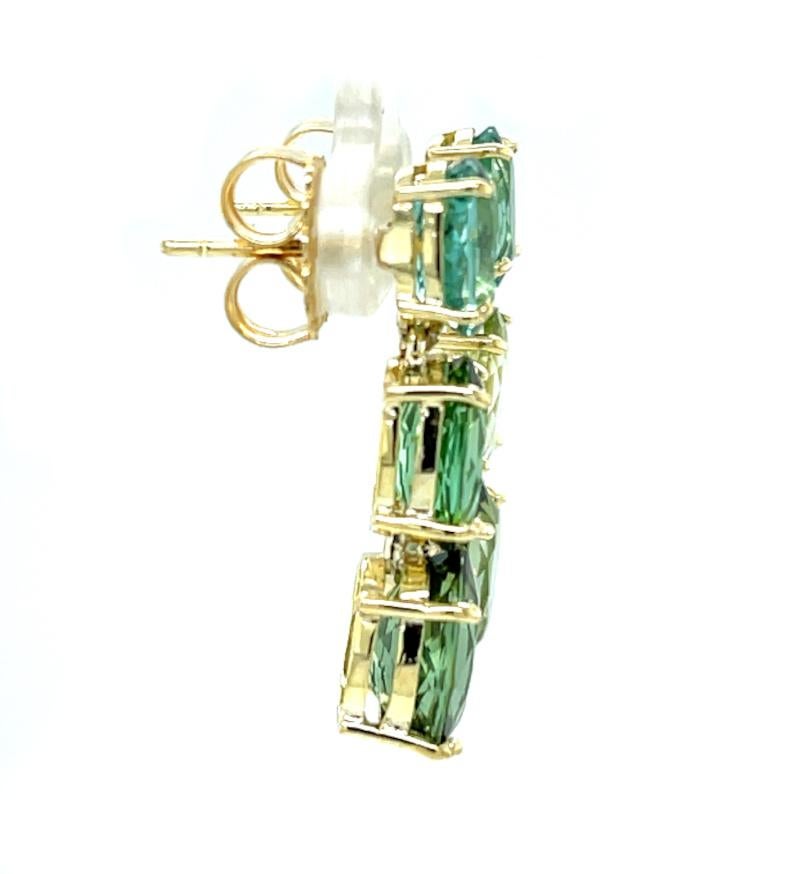 These gorgeous green and blue multi-colored tourmaline earrings are breathtakingly beautiful and one-of-a-kind.  Six sparkling oval tourmalines of varying hues and shades of teal blues and golden greens are set in 18k yellow gold baskets in a