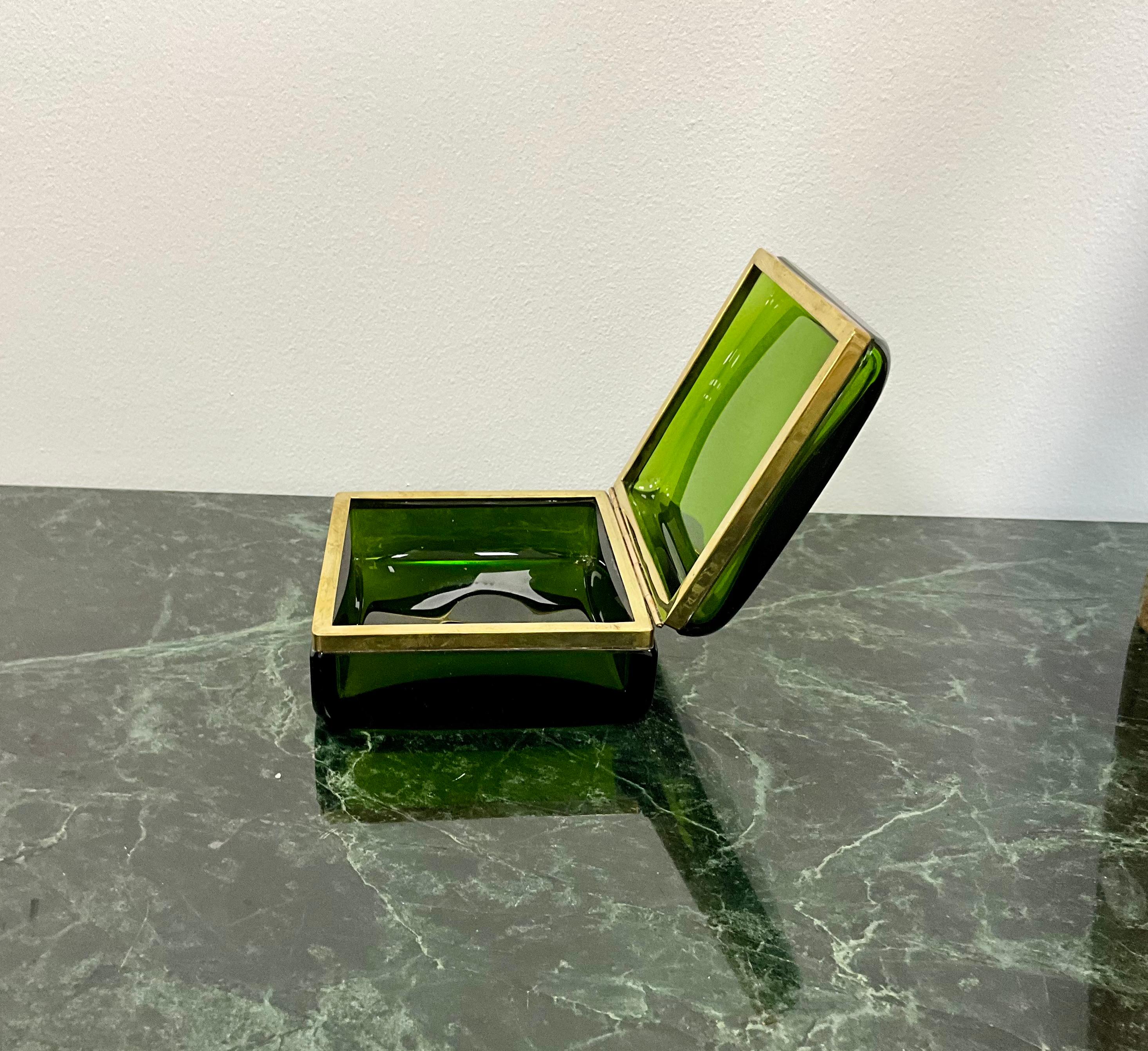 Hinged Murano glass box with brass trim in a stunning green color which brighten with light.. measuring 5’ x 4.5” x 2.5”. Showing minimal signs of wear this is a high quality Art Glass piece.