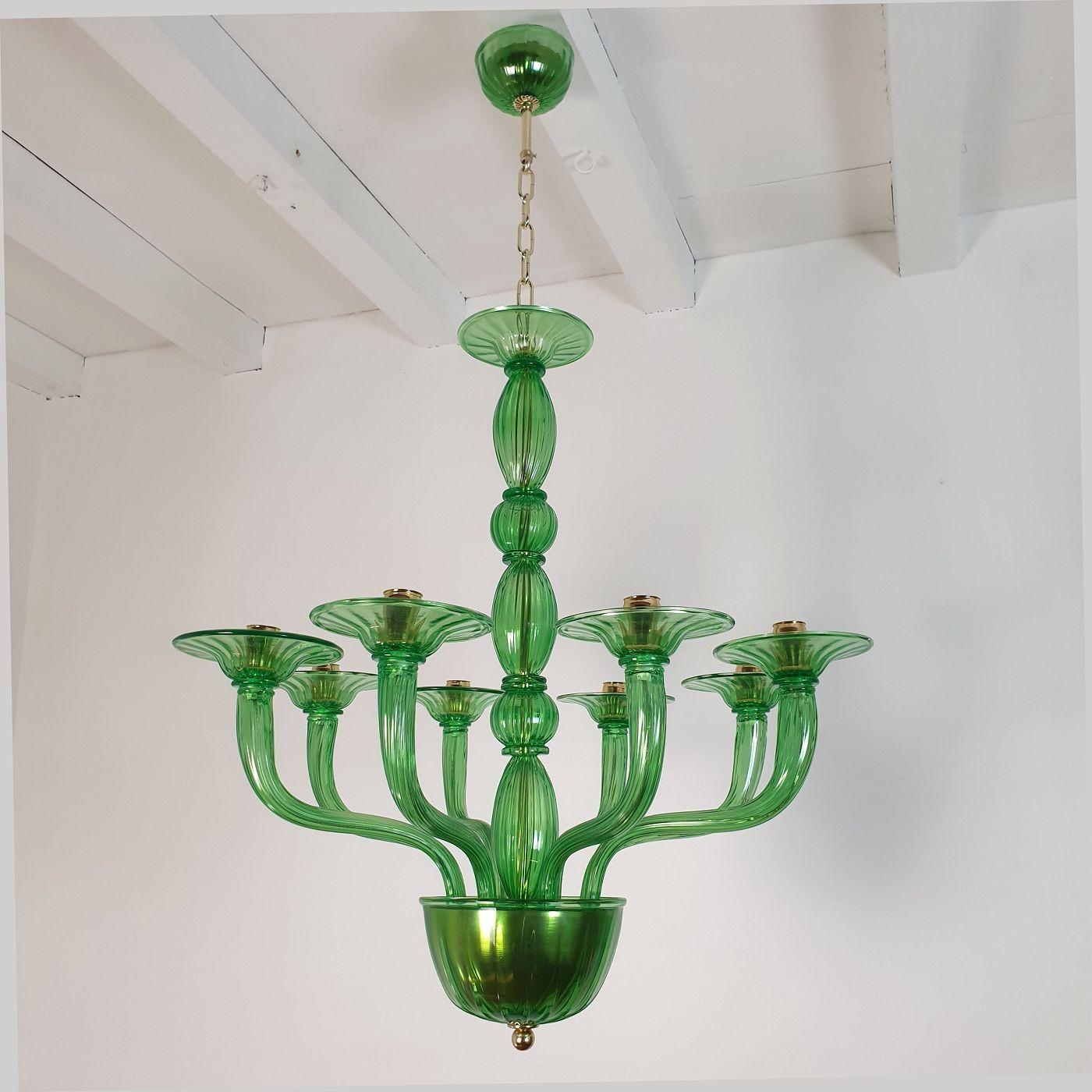 Large Mid Century Modern green Murano glass chandelier, Vistosi style, Italy 1970s.
The vintage Murano glass chandelier has eight lights/arms and is professionally rewired for the US (complimentary European rewiring upon request)
The green