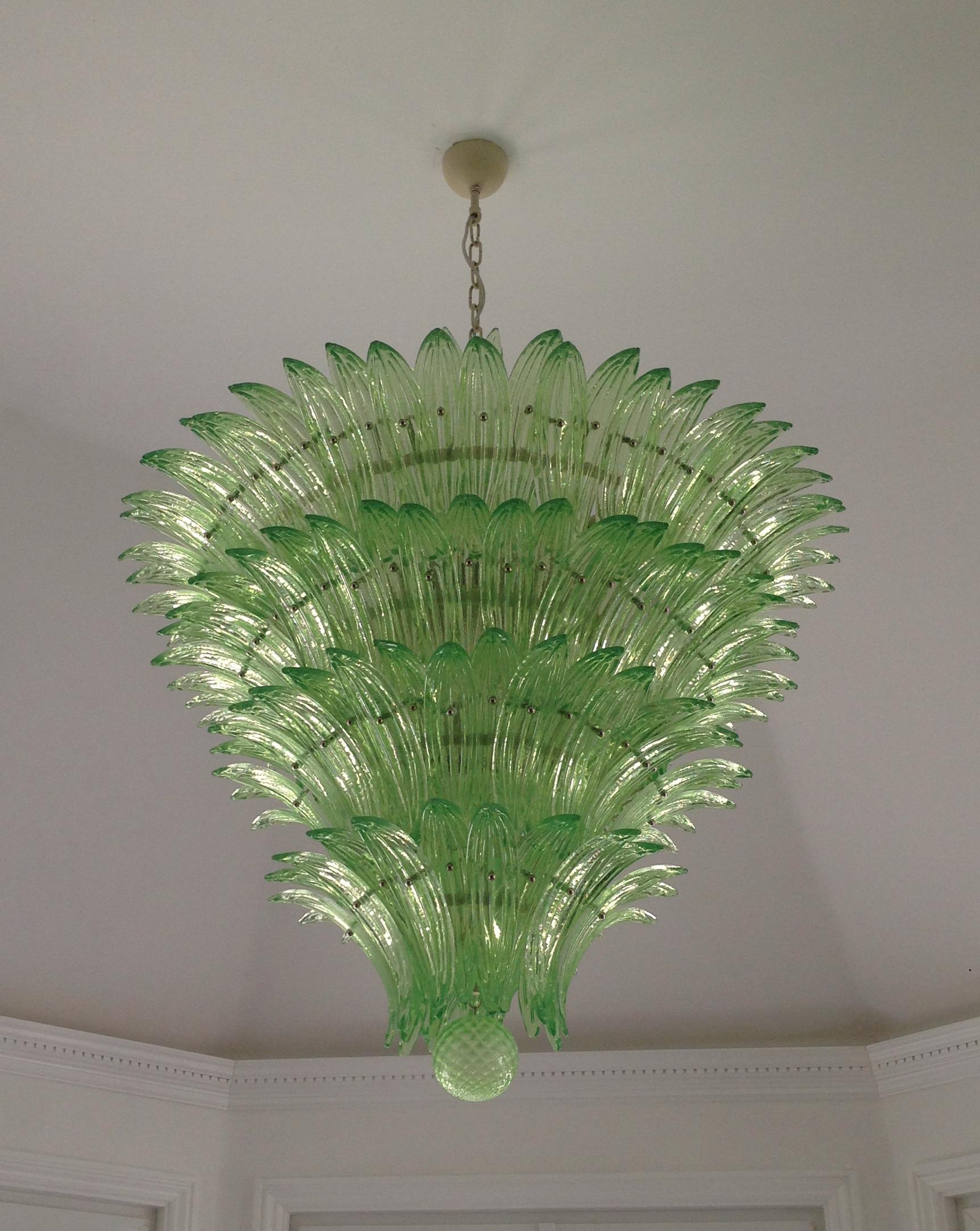 A must have for a magnificent focal point! This chandelier features more than 150 handmade textured green Murano glass palmettes all resting on a structurally beautiful five tier handmade metal skeleton. The glass palmettes are individually placed