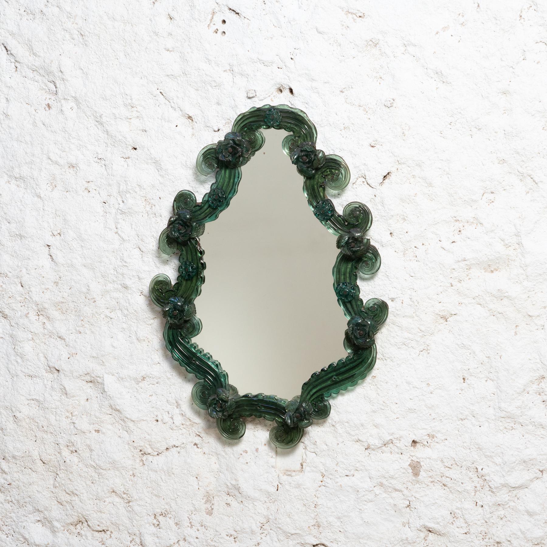 Venetian green mirror in Murano glass.

Traditionally manufactured in Italy, circa 1920.

By unknown designer.

In original condition with minor wear consistently of age and use, preserving a beautiful patina.

Material:
Murano