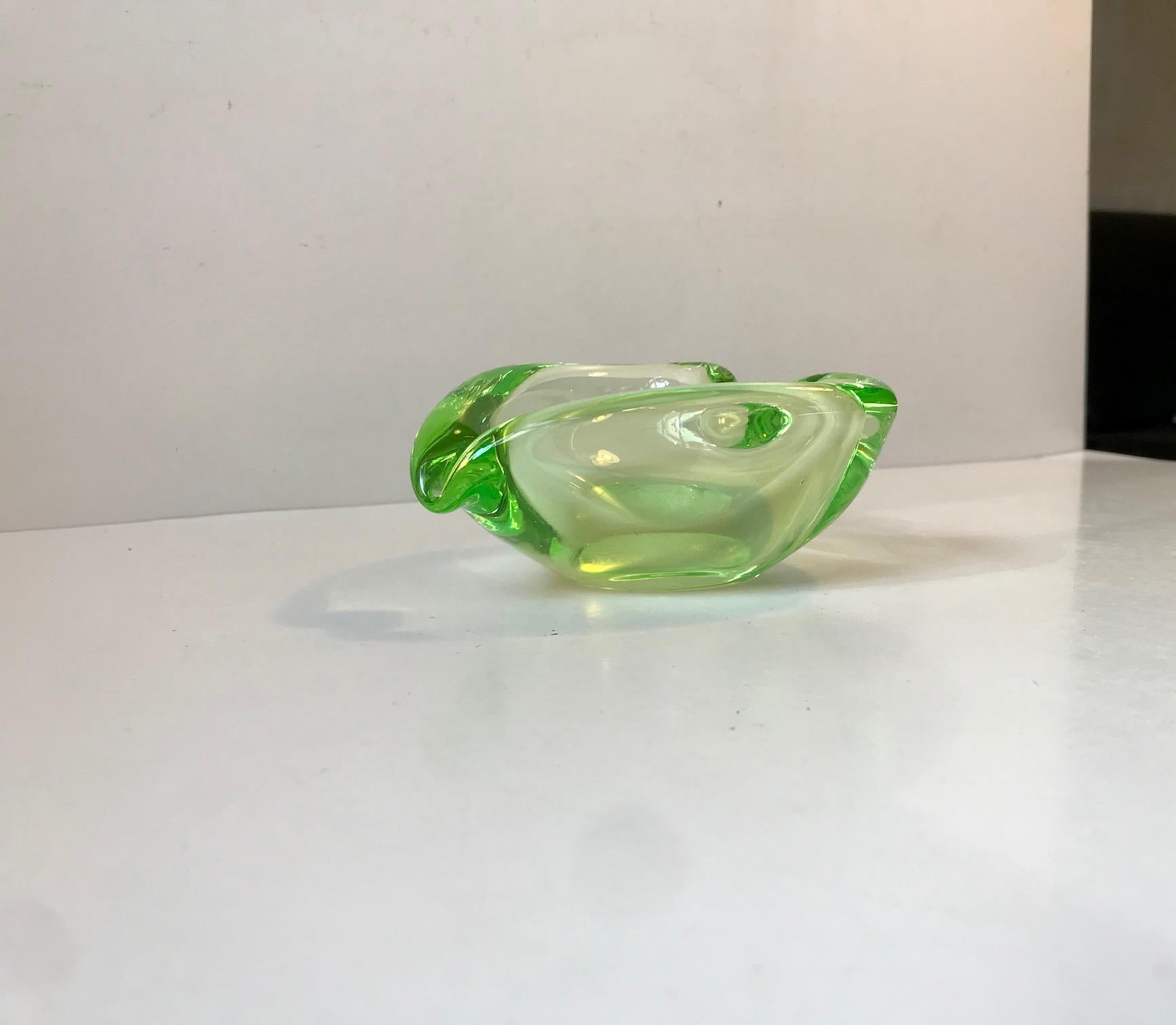 Hand blown collapsed Vaseline art glass dish or ashtray. It is attributed to Archimede Seguso, Italy, circa 1940s-1950s. The 4th photo shows it when the sun hits it.