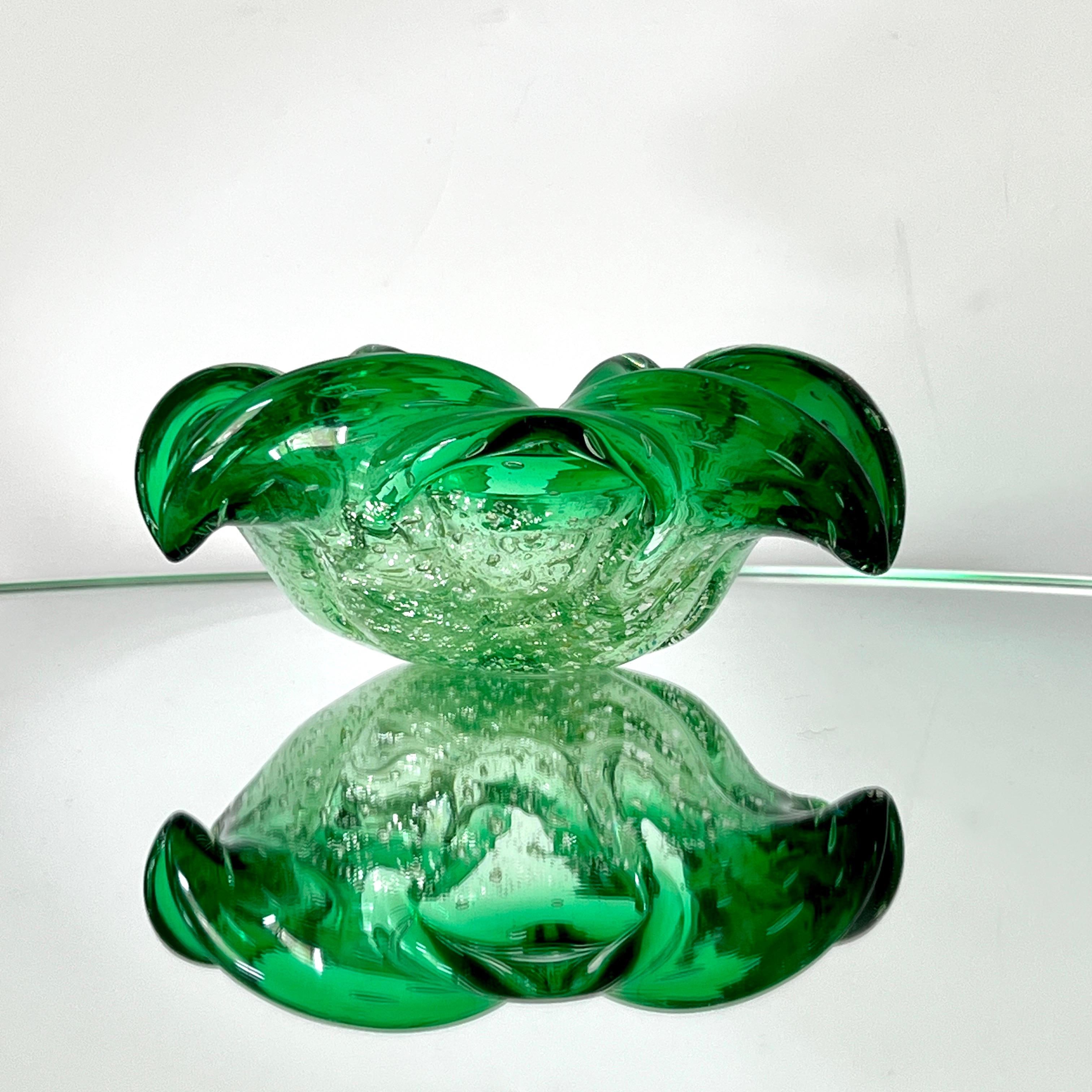 Mid-Century Modern Venetian glass bowl or ashtray with organic floral form. Exquisitely handblown in hues of emerald green. Bowl has bubble glass base design with white gold fleck accents. Features pinched rims with flared sides.