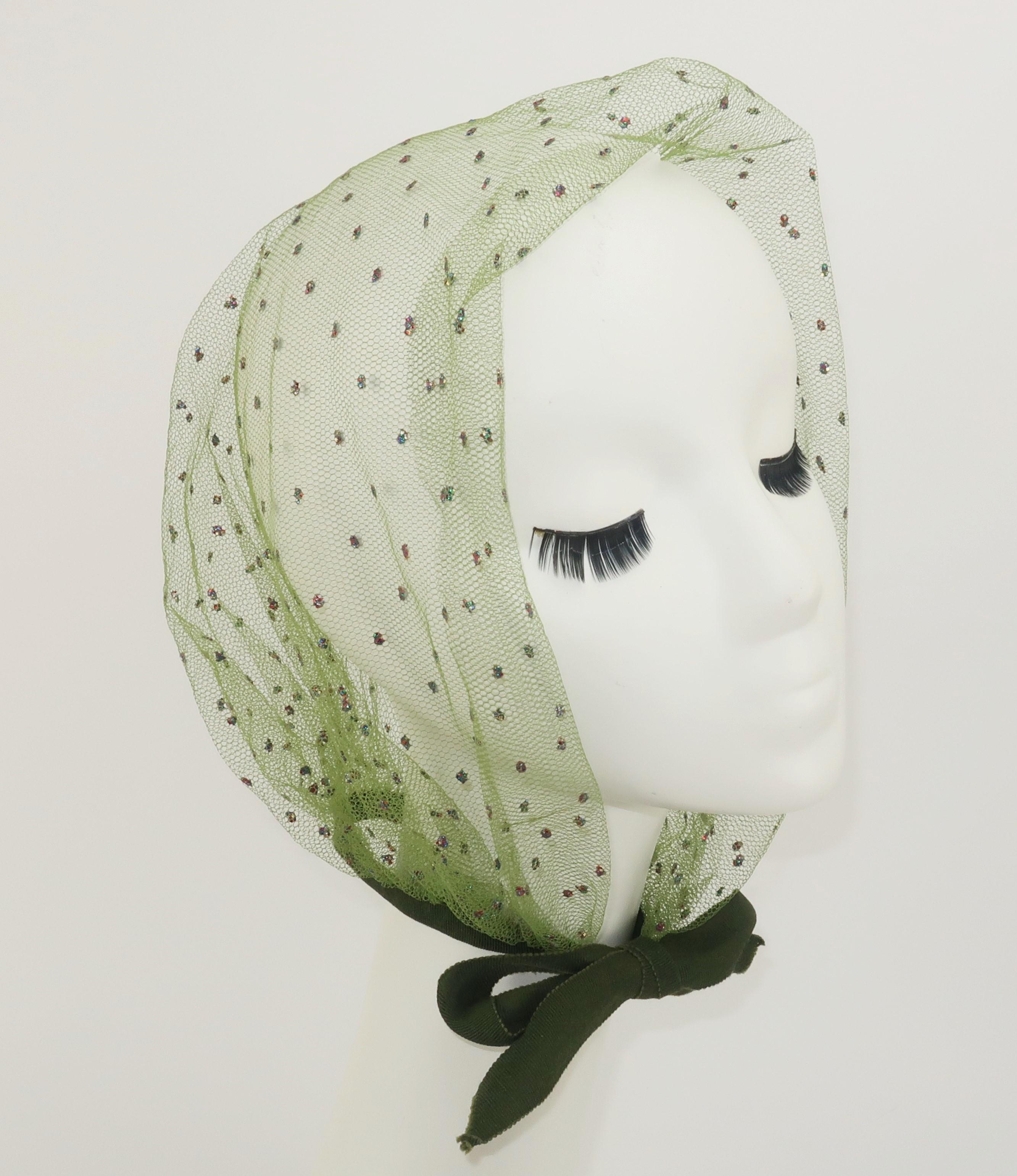 1950's green net head scarf accented with dots of multi color glitter adding a bit of glam to a practical topper that will keep your hair in place when cruising in a convertible ... or anytime the wind threatens to rearrange your locks.  The olive