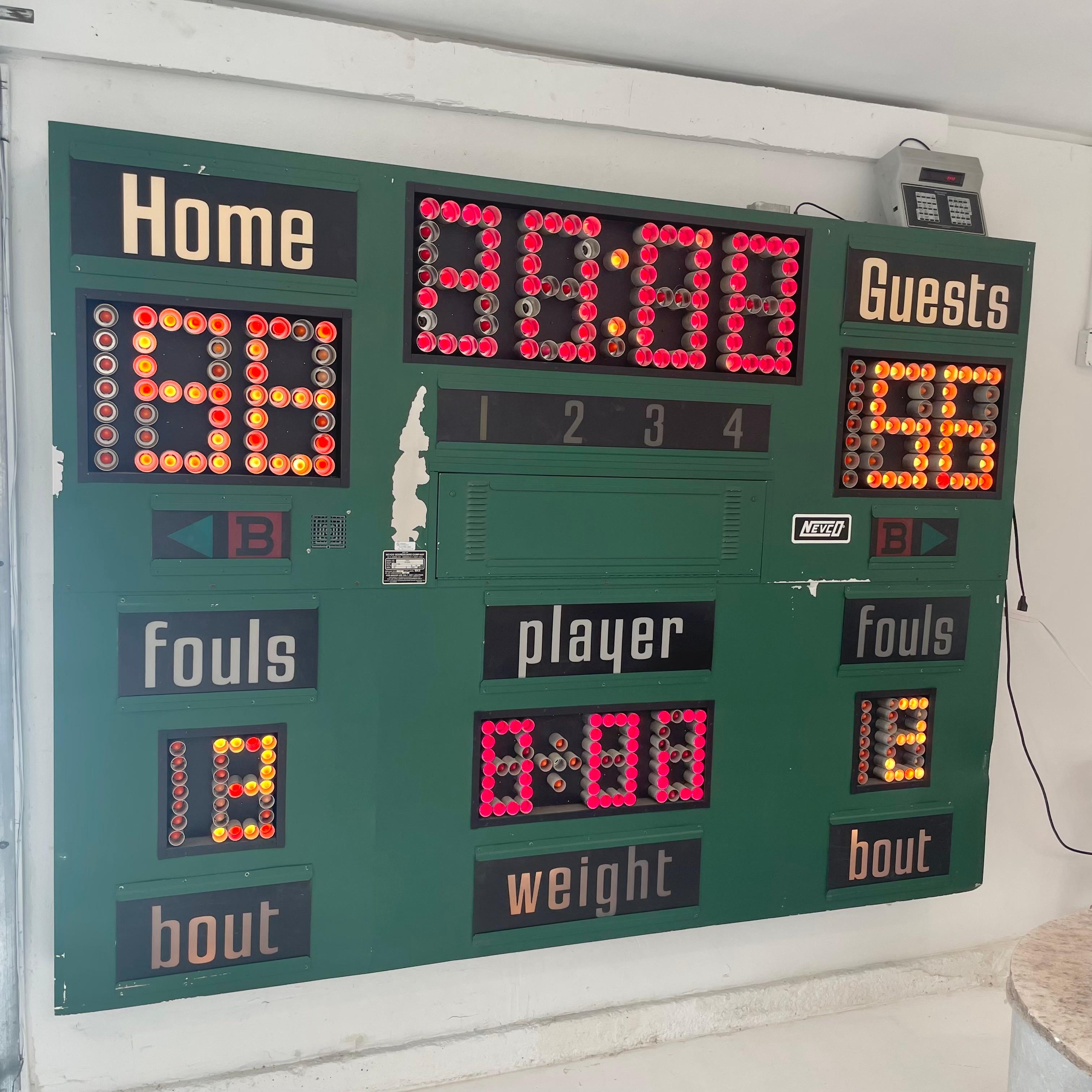 Super fun green metal scoreboard by Nevco. Made in 1998 in the US. Can be used for multiple sports. This one was made specially for wrestling. 100% functional. Running clock, guest and home score, player, fouls, weight, quarter and bonus. The player