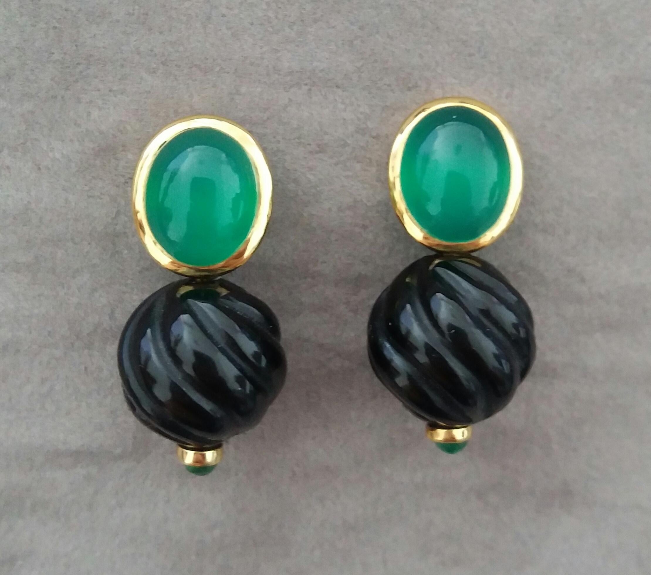 These unique and simple but elegant earrings are completely handmade and combines the Black Onix round carved beads of 13 mm in diameter with small Emeralds cabs on the bottom side suspended to a couple of Oval Green Onyx cabochons measuring 10 x 12