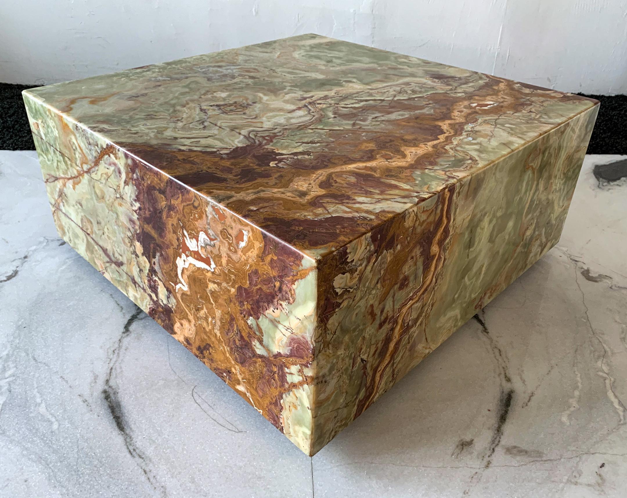 Available right now we have an absolutely stunning green onyx coffee table. This green onyx coffee table features a stunning red, white, and brown veining throughout and is simply beautiful. This square coffee table, appears to be floating on the