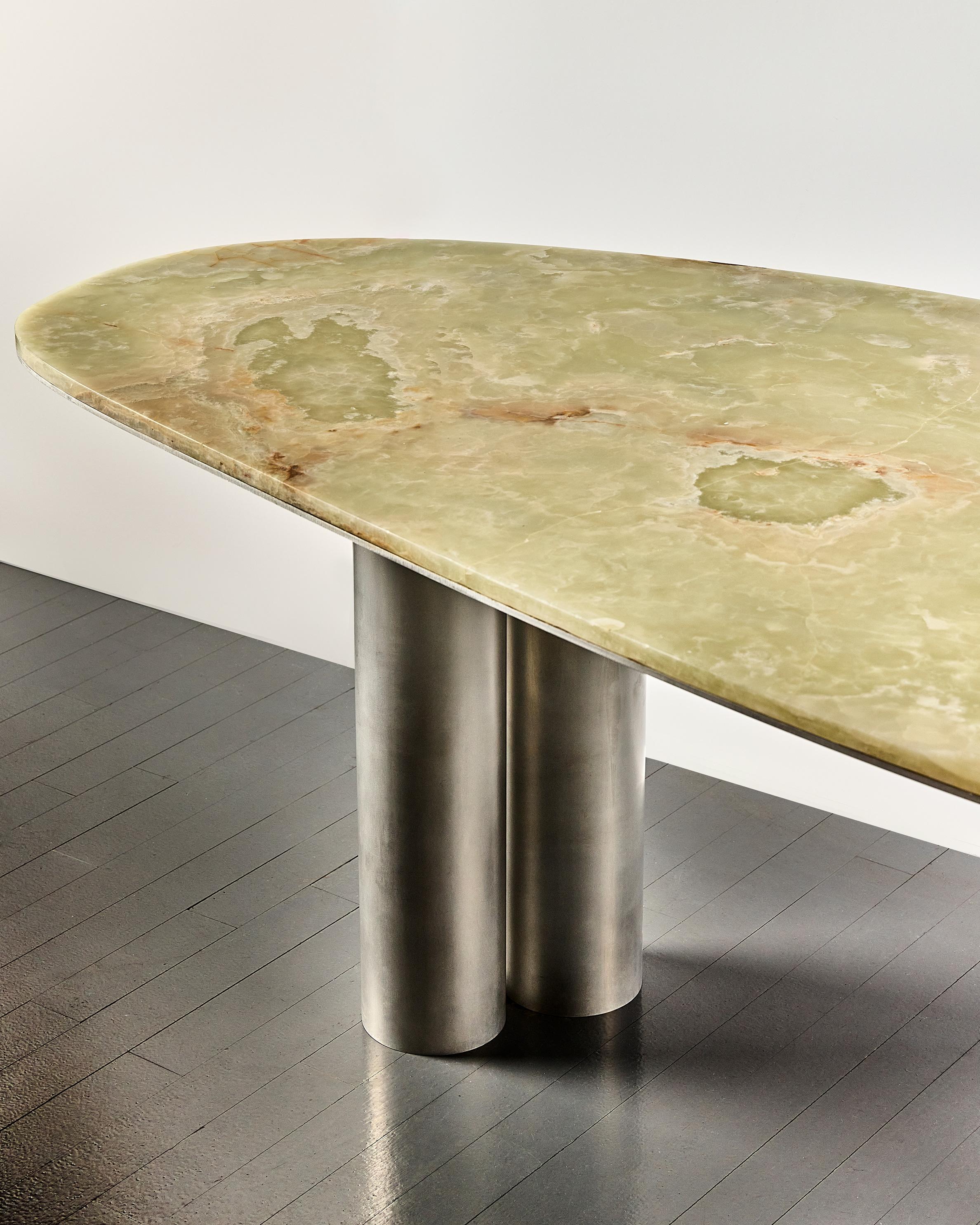 Celebrating nature's inherent beauty, the Oni Desk embraces the irregular shape of a found Green Onyx slab. This desk's innovative design is informed by the unique constraints of the stone, resulting in a mesmerizing and one-of-a-kind form. The