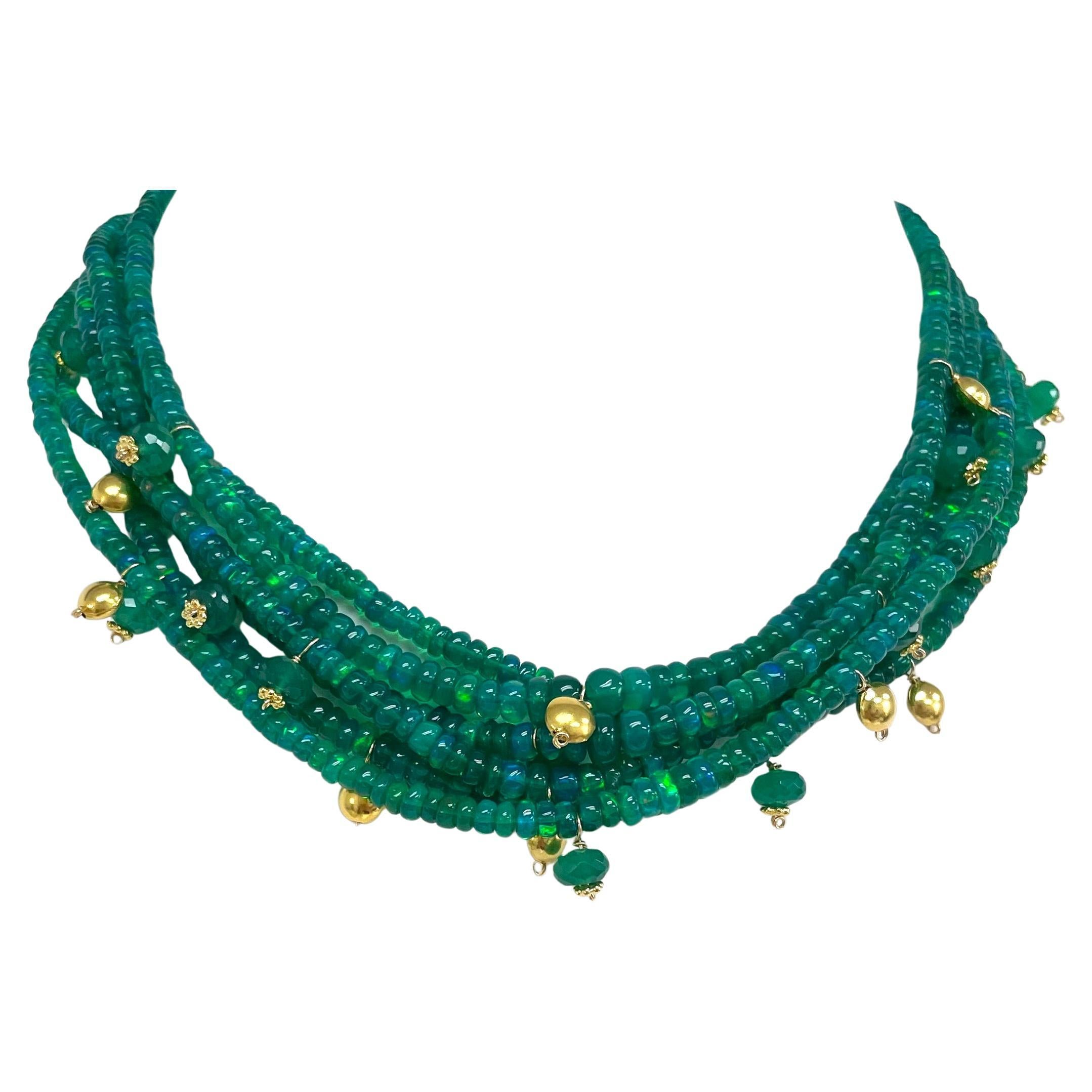 Description
Vibrant, luminous, iridescent green Hydrophane Ethiopian Opal 5 strand necklace embellished with lentil shape 18k yellow gold and green onyx accents.
Item # N3795. 
Check out complementary earrings, (see photo),  Item # E3080 ($4,000)