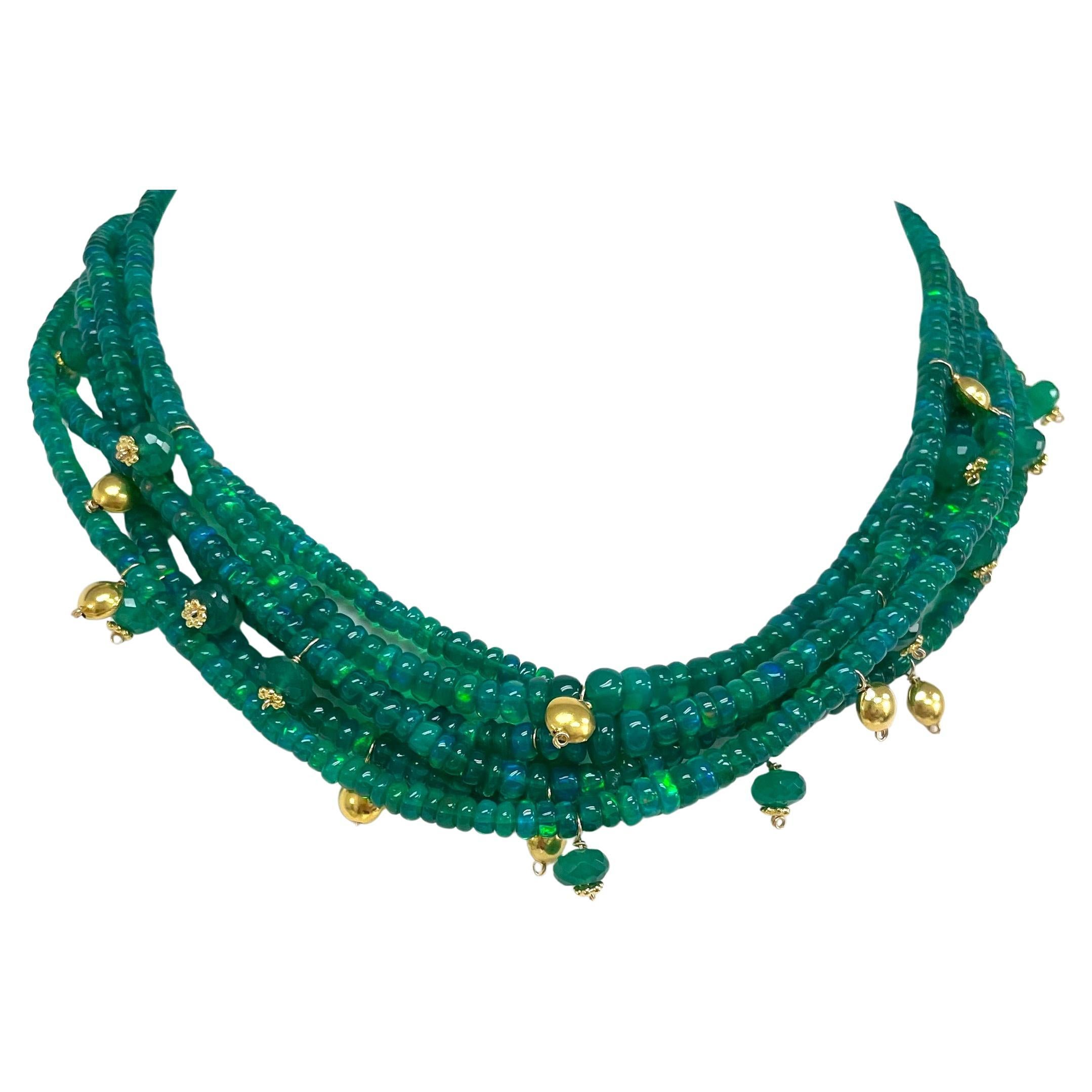 Descrizione
Vibrante, luminosa e iridescente collana a 5 fili di opale etiope verde Hydrophane impreziosita da lenticchie in oro giallo 18k e accenti di onice verde.
Articolo # N3795. 
Guarda gli orecchini complementari (vedi foto),  Articolo n.