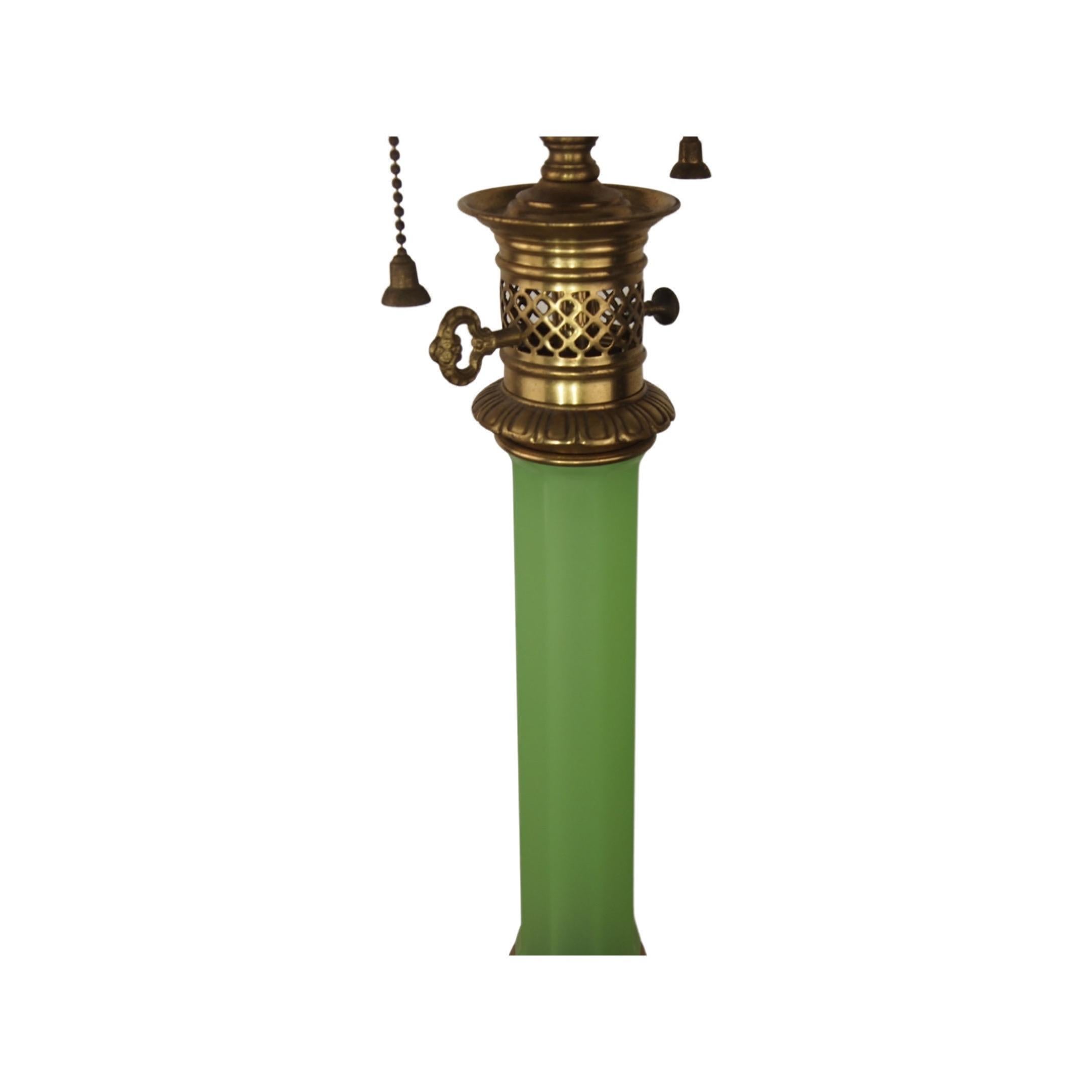 French Mid-Century Modern green opaline column with solid brass fittings sitting atop a round brass base. Retains original label of Warren Kessler, NY. Double bulb cluster with pull chain sockets. Shade height is adjustable. Wired and in good