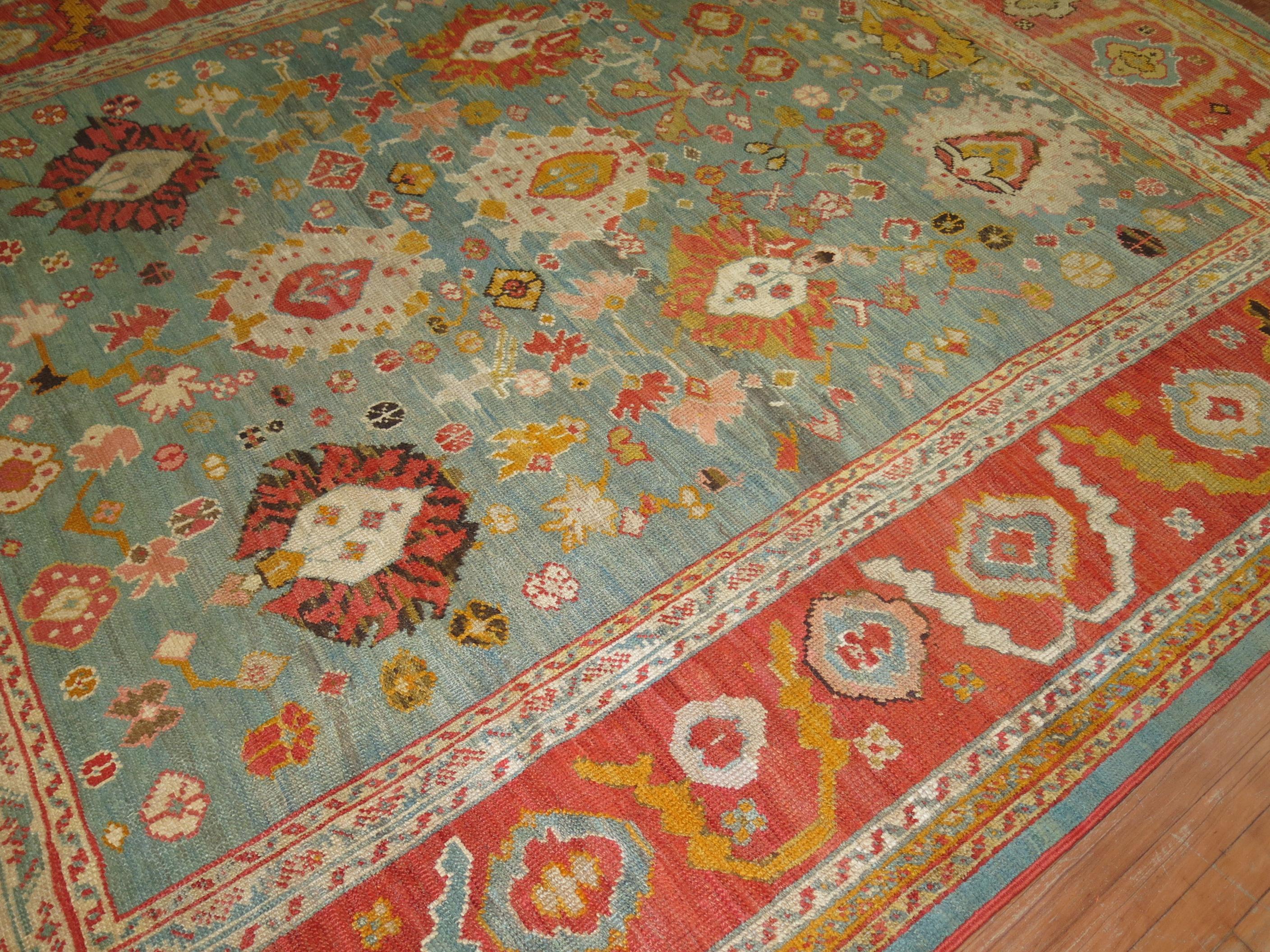 An exhilarating room size early 20th century antique turkish oushak rug with a vivid green field and orangy red border.

8'10'' x 11'2''