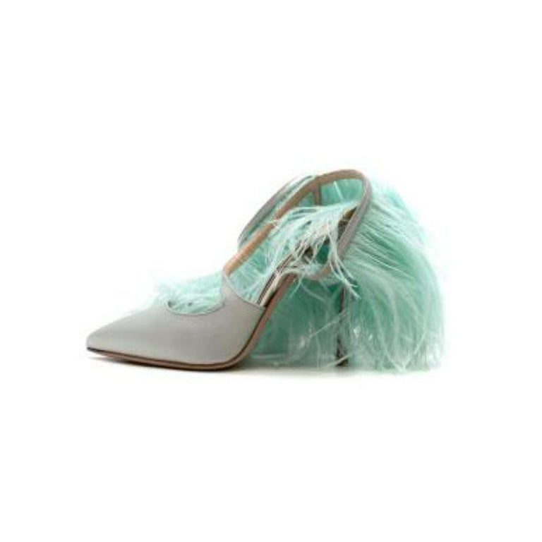 Giambattista Vali Green Feather Slingbacks
 
 - Crafted in pastel green silk satin 
 - Cross strap with a swish effect marabou feather trim 
 - Set on a stiletto heel with a pointed toe 
 
 Materials
 Ostrich feather 
 Silk satin 
 
 Made In Italy 
