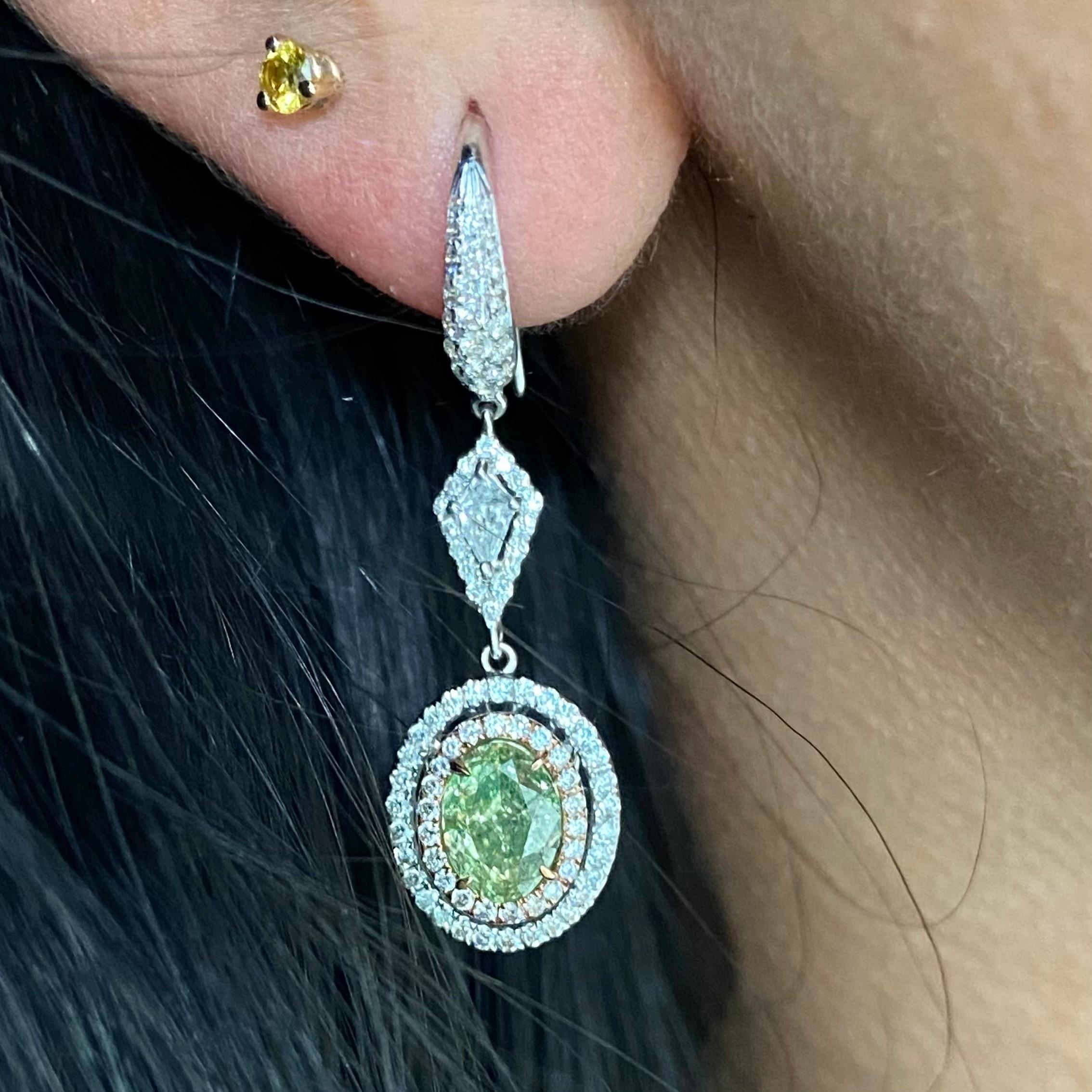 1.00 Carat and 1.05 Carat Center Oval Cut Diamonds
GIA Certified Fancy Greenish Yellow Diamonds
SI1 and SI2 Clarity
1.15 Carat surrounding white diamonds
3.20 Carat Total Weight
18k White Gold
Handmade in NYC  

This piece can be viewed before