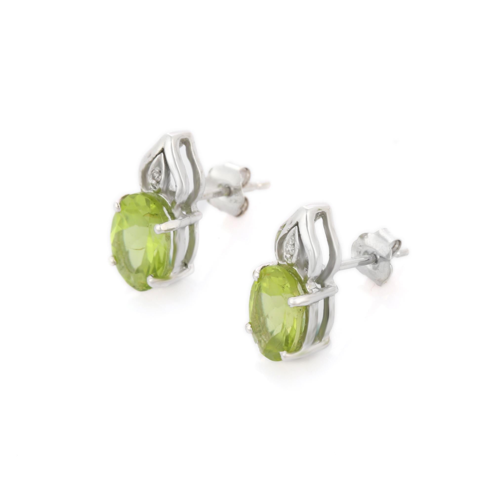 Studs create a subtle beauty while showcasing the colors of the natural precious gemstones and illuminating diamonds making a statement.

Oval cut peridot studs with diamonds in 14K gold. Embrace your look with these stunning pair of earrings