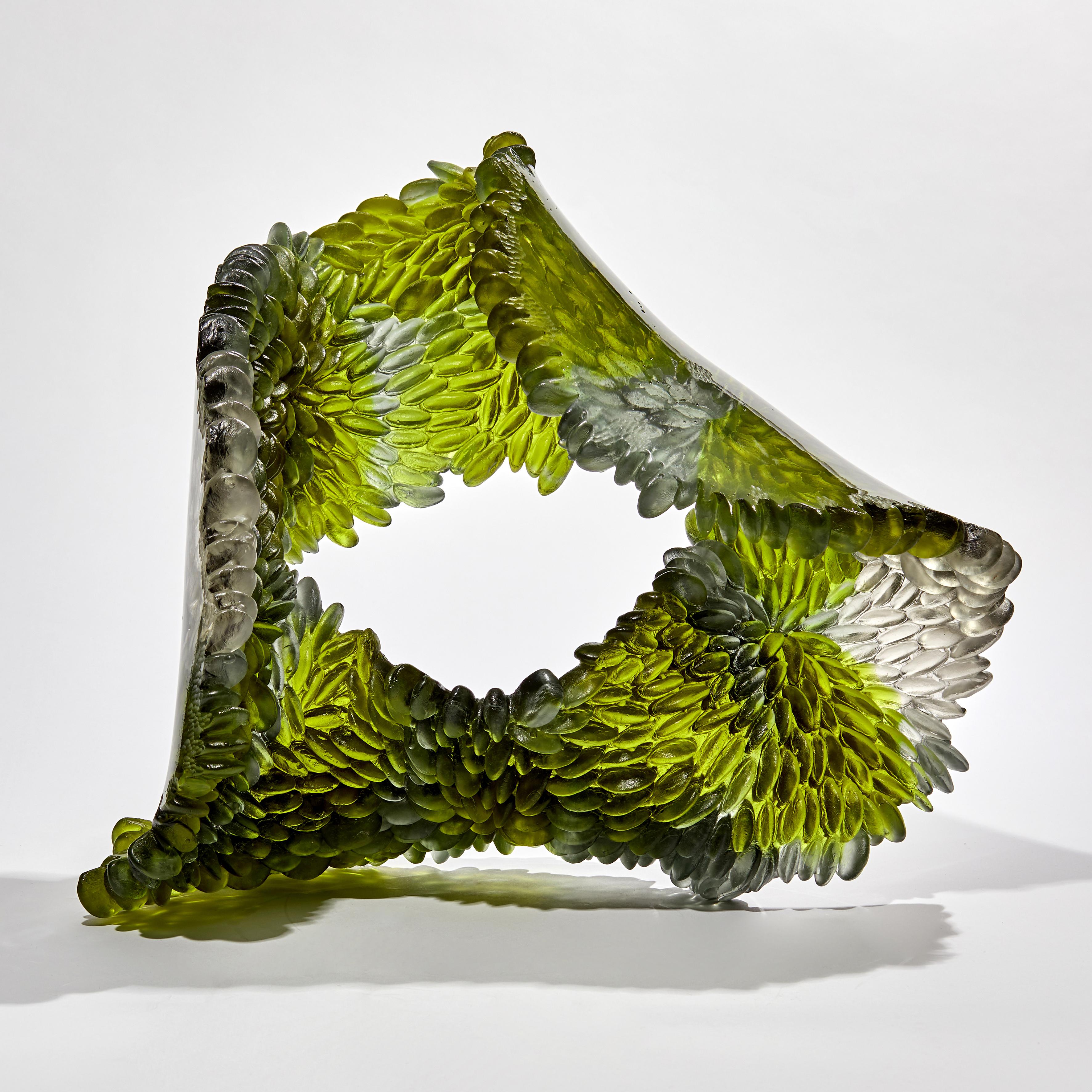 Green Oval is a unique textured glass sculpture in olive green and light grey by the British artist Nina Casson McGarva.

Casson McGarva firstly casts her glass in a flat mould where she introduces all of the beautifully detailed, scaled surface