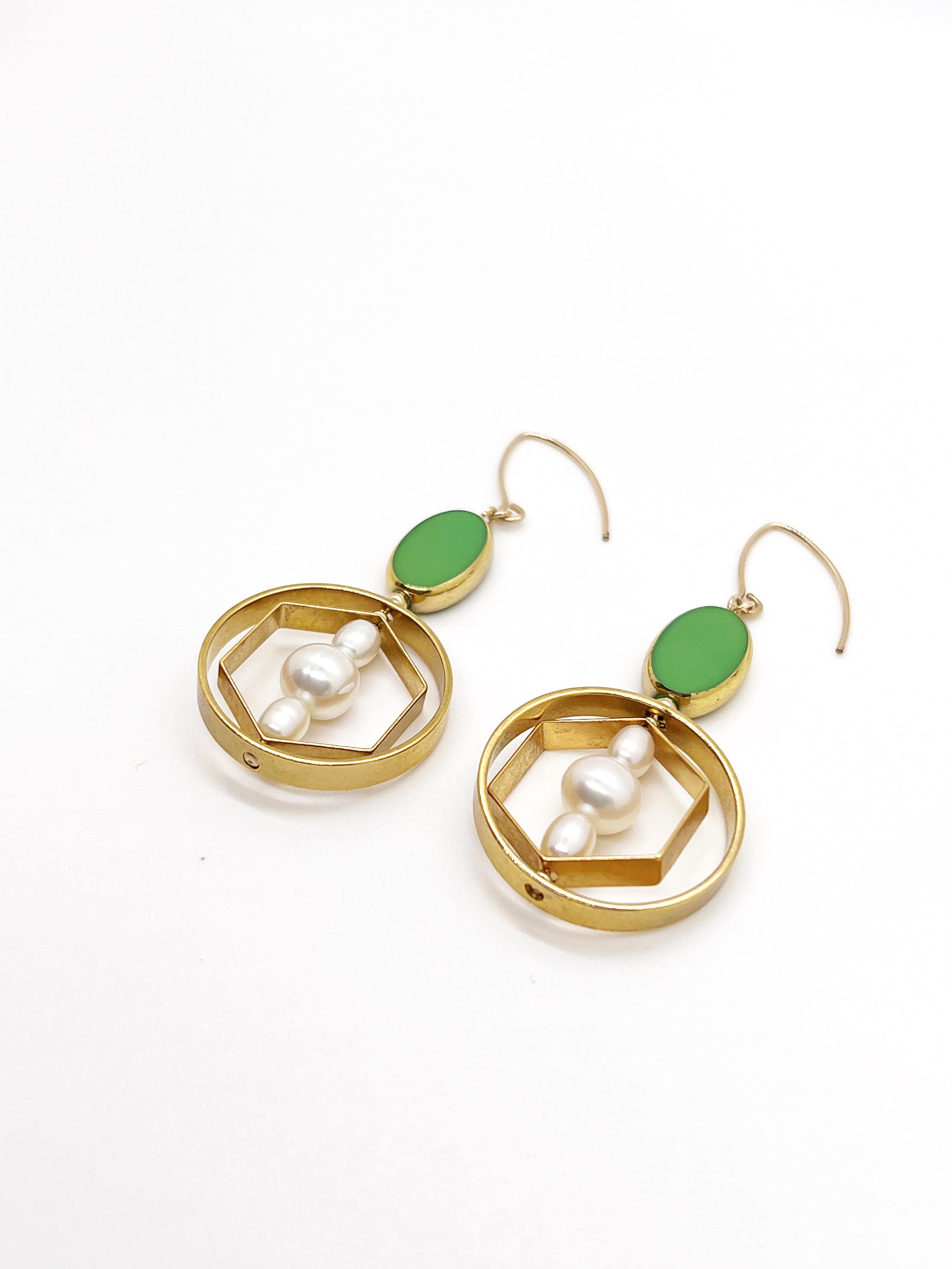 These earrings are light weight. It is composed of Green Oval  German Vintage Glass Beads that are edged with 24K gold. It is incorporated with oval freshwater pearls set in a 24K gold plated brass geometric frame. The earrings had been e-coated for