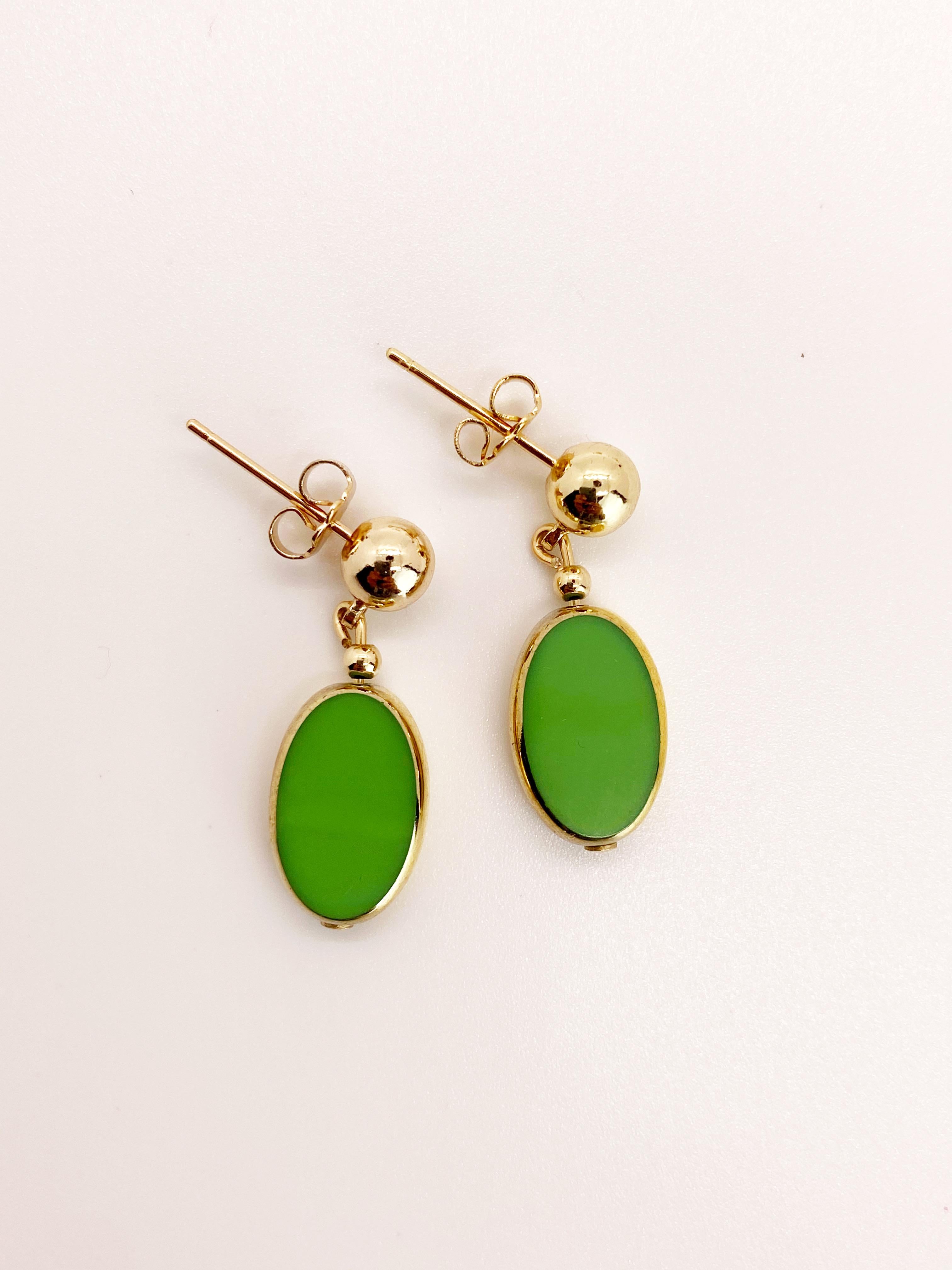 Green Oval German vintage glass beads edged with 24K gold dangles on a 6mm ball 14K gold filled earring post. 

The German vintage glass beads are considered rare and collectible, circa 1920s-1960s.