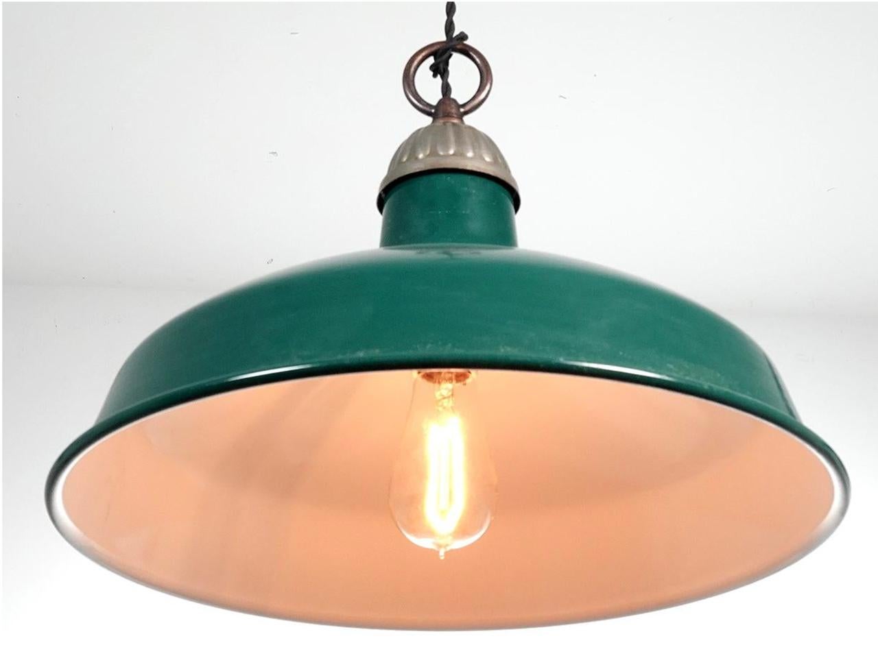 This was the type of simple industrial lamp often used in barns and factories. We found a good collection of these and all are in beautiful unused condition. New Old Stock. They have an impressive 16 inch diameter. The top is crowned by a small