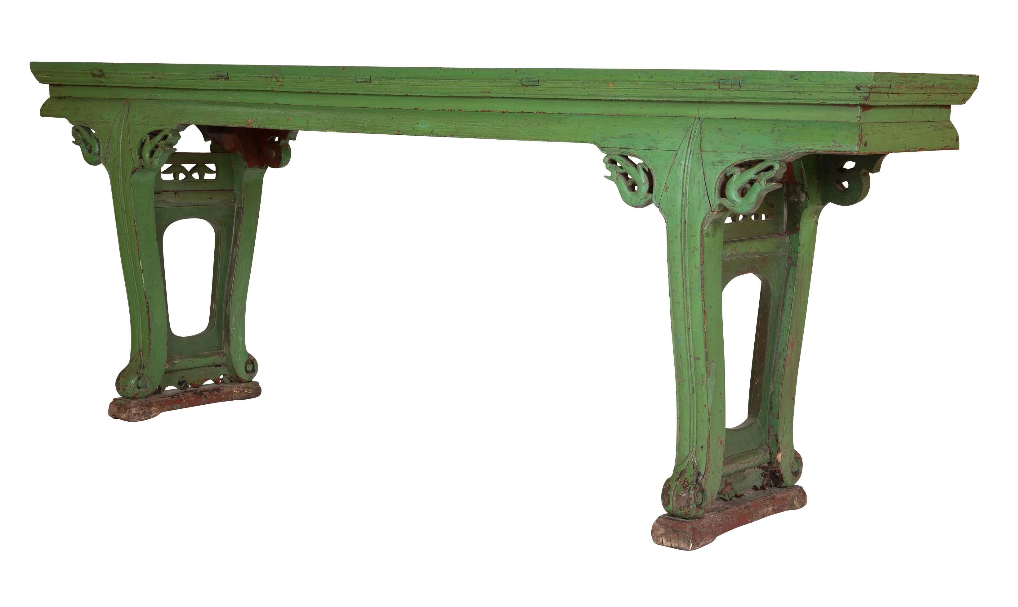 A very decorative 19th century Chinese altar table with apple green paint. Impressive in it's large scale at 8 feet across by 3 feet high, this piece will make a room as a unique console or sofa table. Of classic design with stylized dragons at the