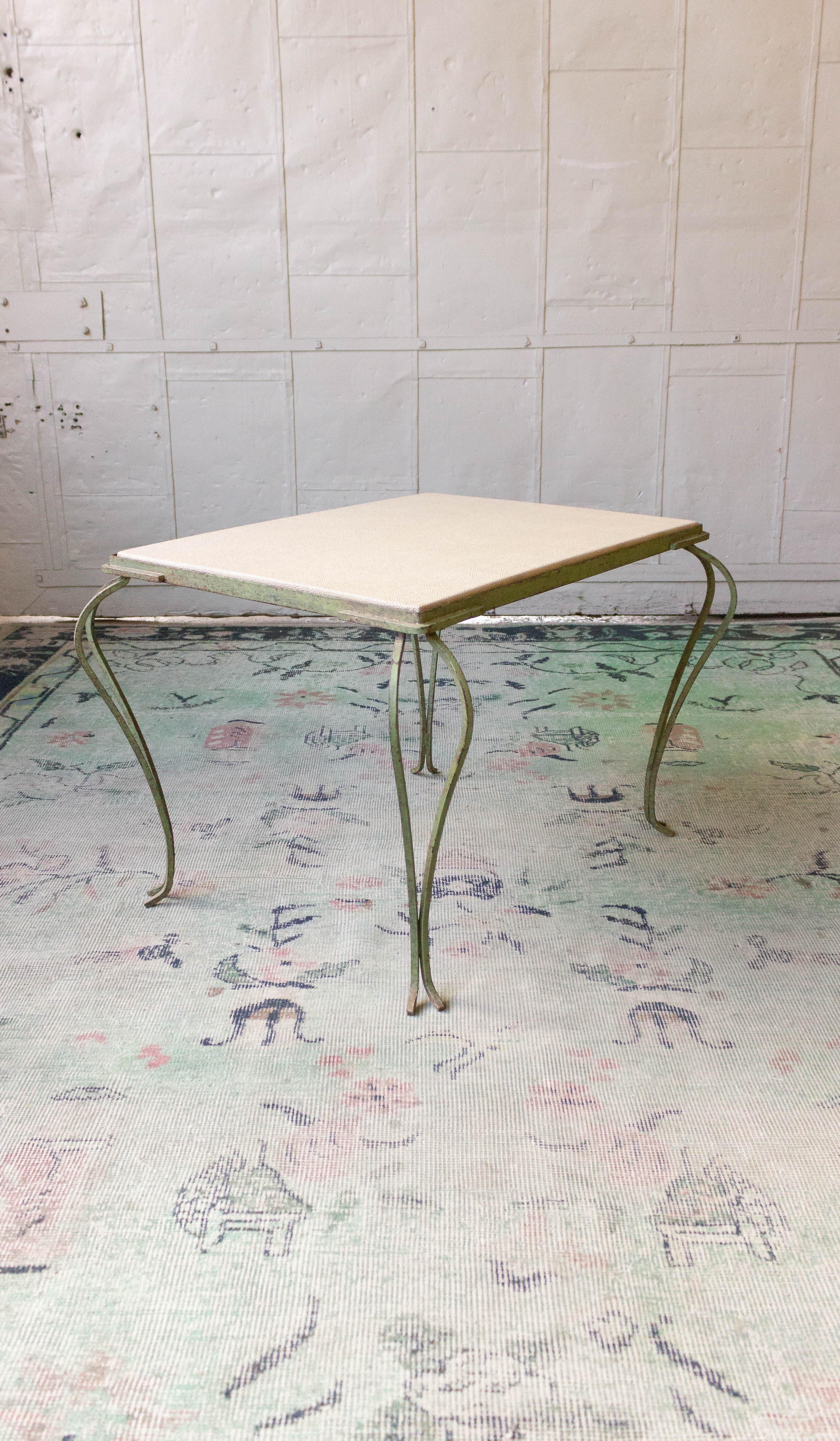 An unusual distressed painted coffee table with double cabriolet legs. The top has recently been recovered with a water and stain faux shagreen vinyl, French, 1950s.