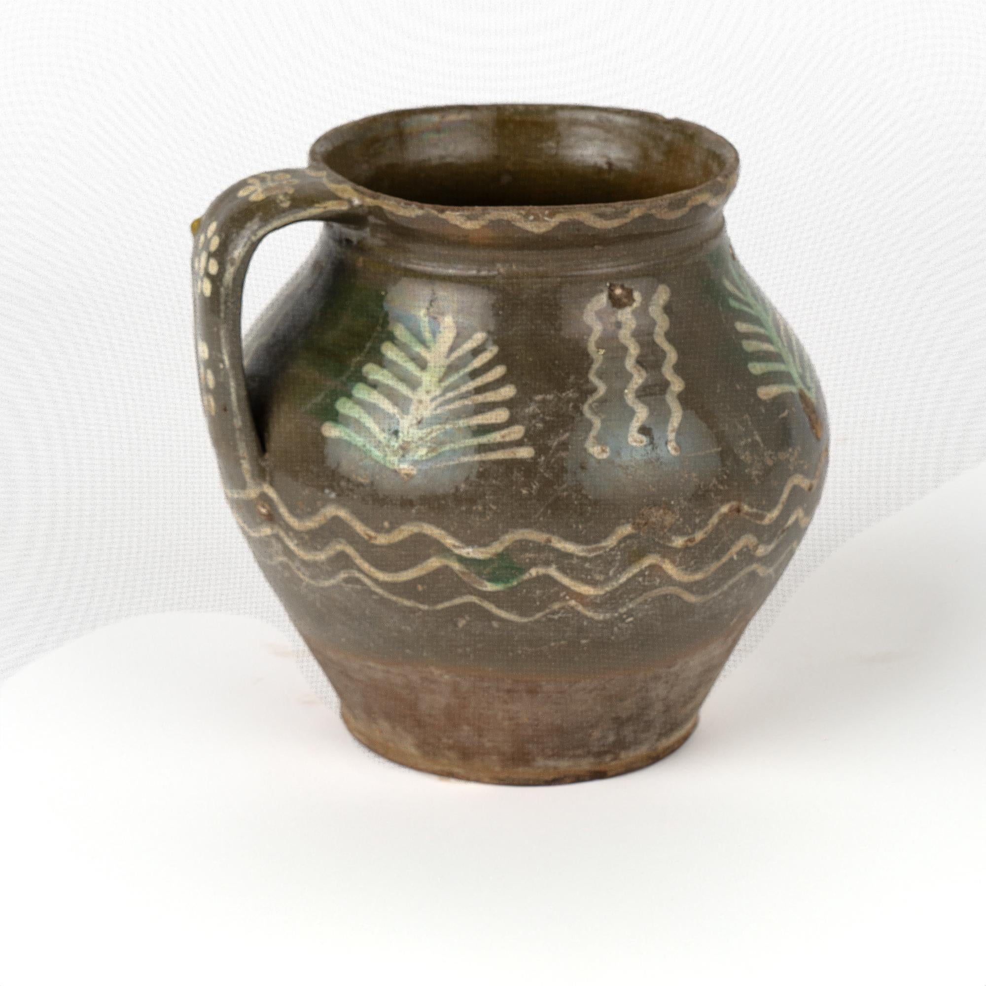 Original hand painted earthenware pottery with handle, olive green background. 
Sold in original vintage used condition. Any chips, cracks, distress to paint or pottery is reflective of age and use. Solid condition.

With over 37 years of experience