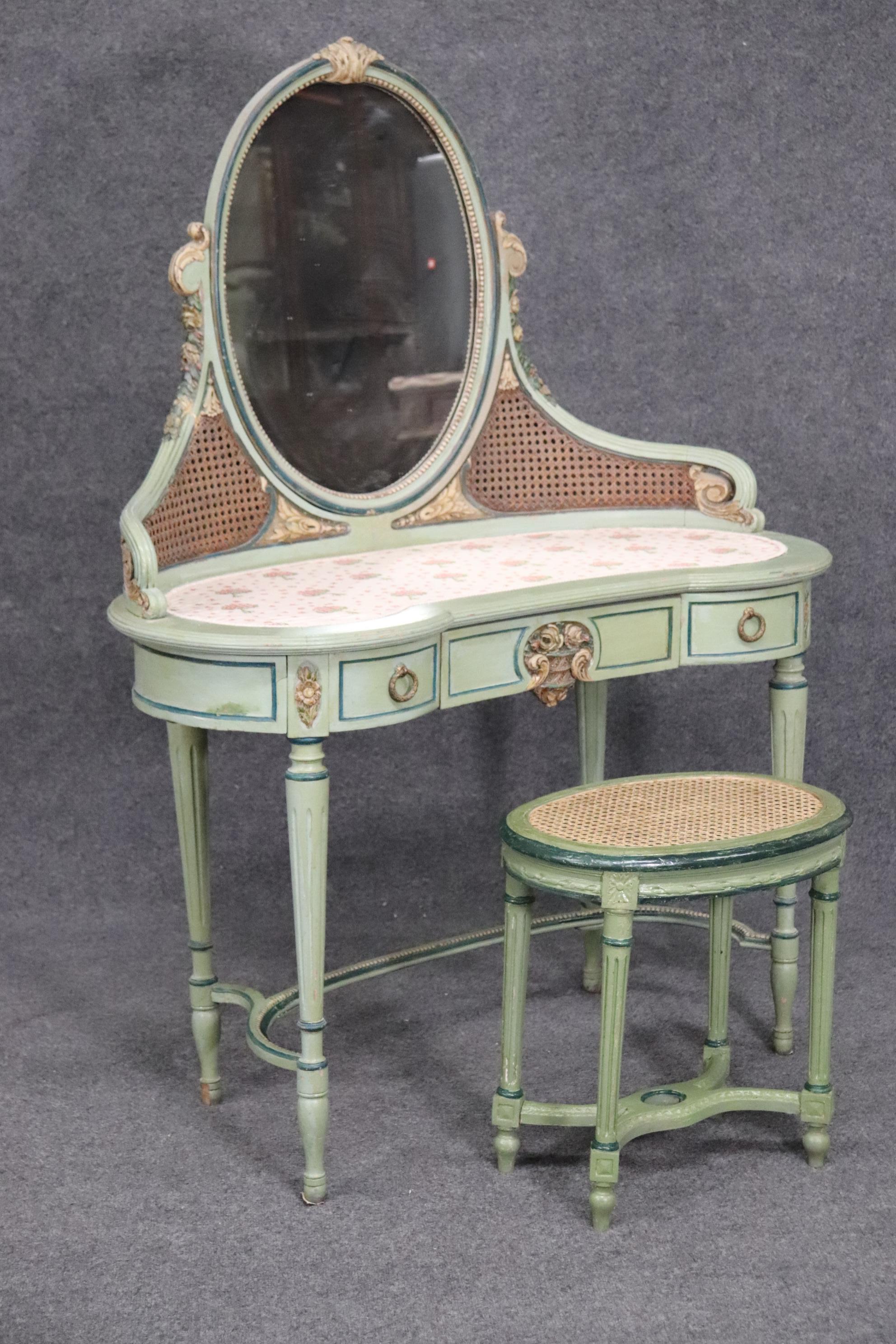This is a beautiful French 1920s ladies vanity and matching stool. The vanity is in good original condition. The vanity measures 45 wide x 21 deep x 58 inches tall and the stool is 20 inches tall x 20 inches deep x 14 inches wide.