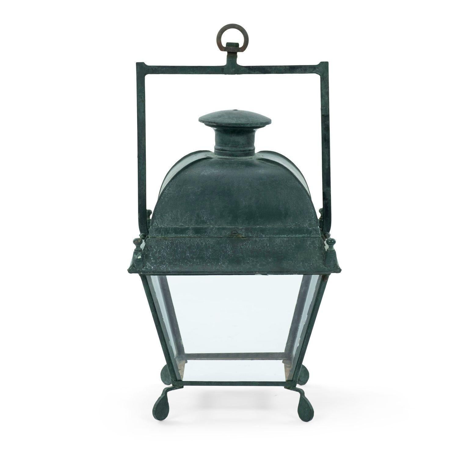 Green-painted French tole stable lantern with domed top and four glass paneled sides. Dates to early 20th century. Not wired. Two available (last three images show lanterns ref. 1013A and 1013B together) but sold individually priced $3,800