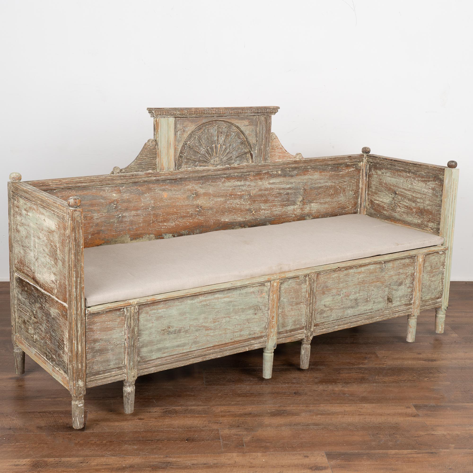 This exceptional Gustavian bench is a special find. Note the original pale green painted finish, now scraped down revealing a warm aged patina reflecting the age and grace of this lovely bench.
The finials, feet, and decorative carved details of