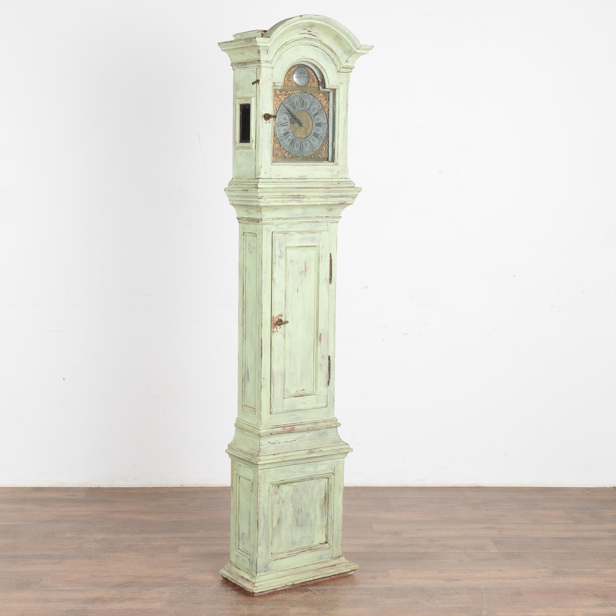 The curved bonnet, simple panel door, and slender case with lovely balance to face and base are all highlights of this delightful grandfather clock that stands just over 6' tall.
Take a close look at the intricate details of the original face and