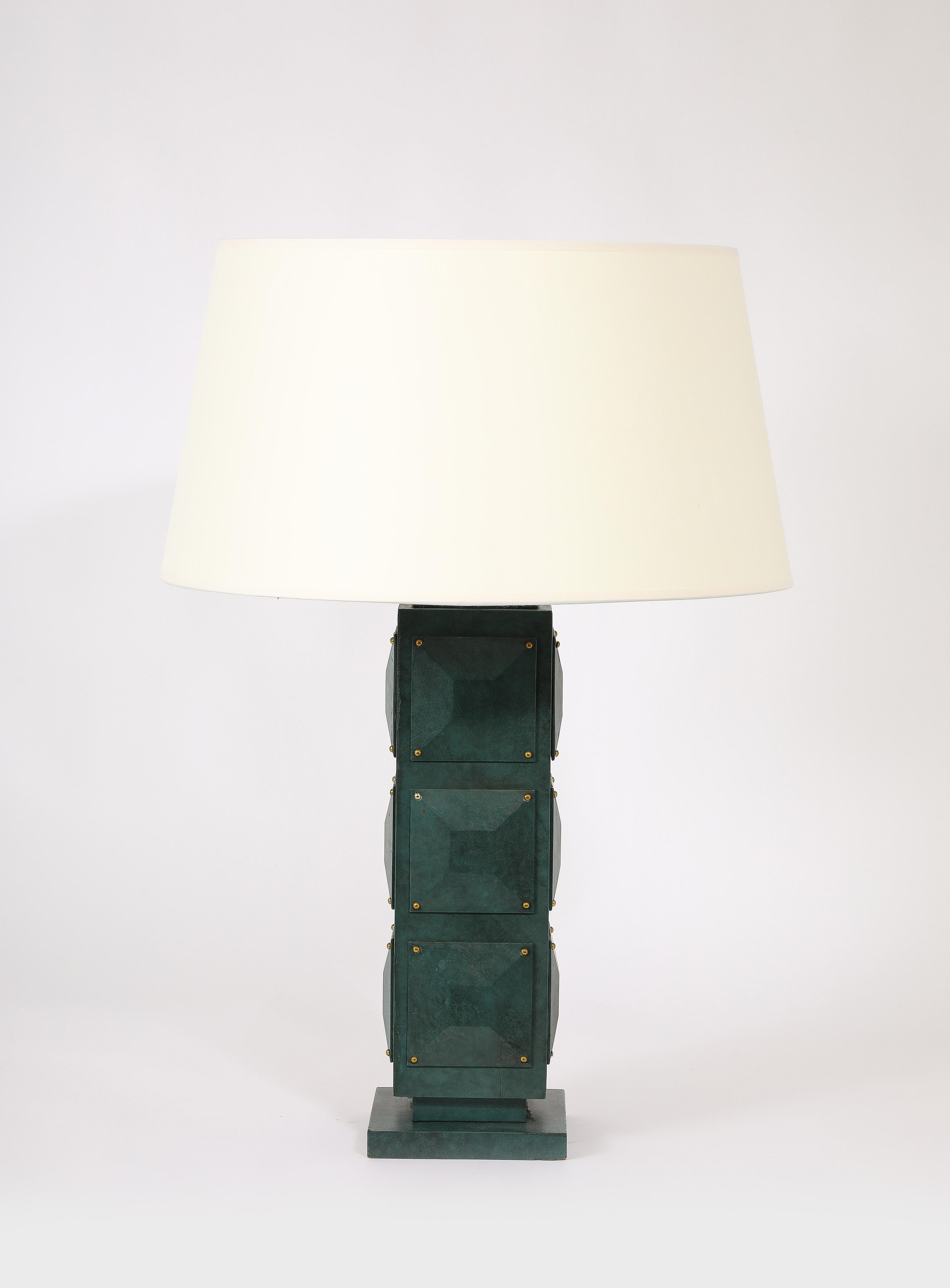 Large diamond faceted table lamp on a plinth with brass nails.