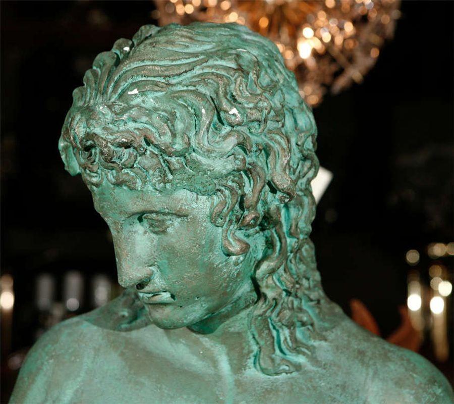 A male nude statue in green patina plaster. Made to look like aged copper or bronze.
Dimensions:

Height: 35.5 in.
Width: 16 in.
Depth: 9 in.