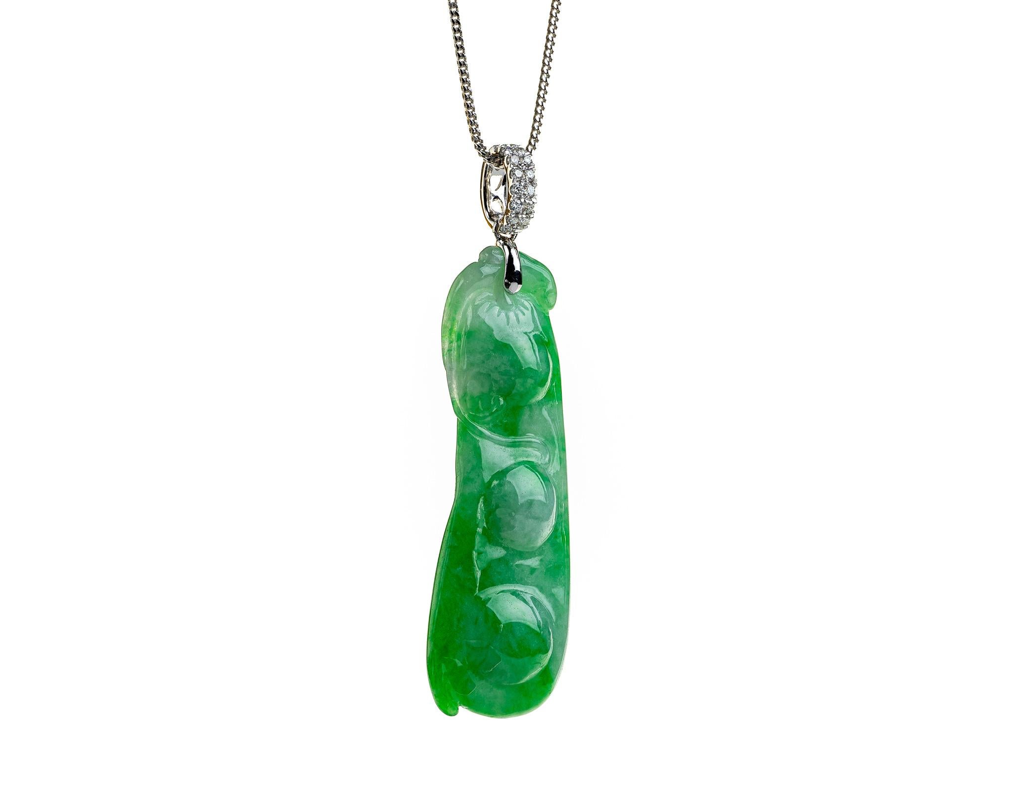This is an all natural, untreated jadeite jade carved peapod pendant set on an 18K white gold and diamond bail.  The carved peapod represents happiness, prosperity and longevity. 

It measures 0.60 inches (15.4mm) x 1.87 inches (47.7mm) with