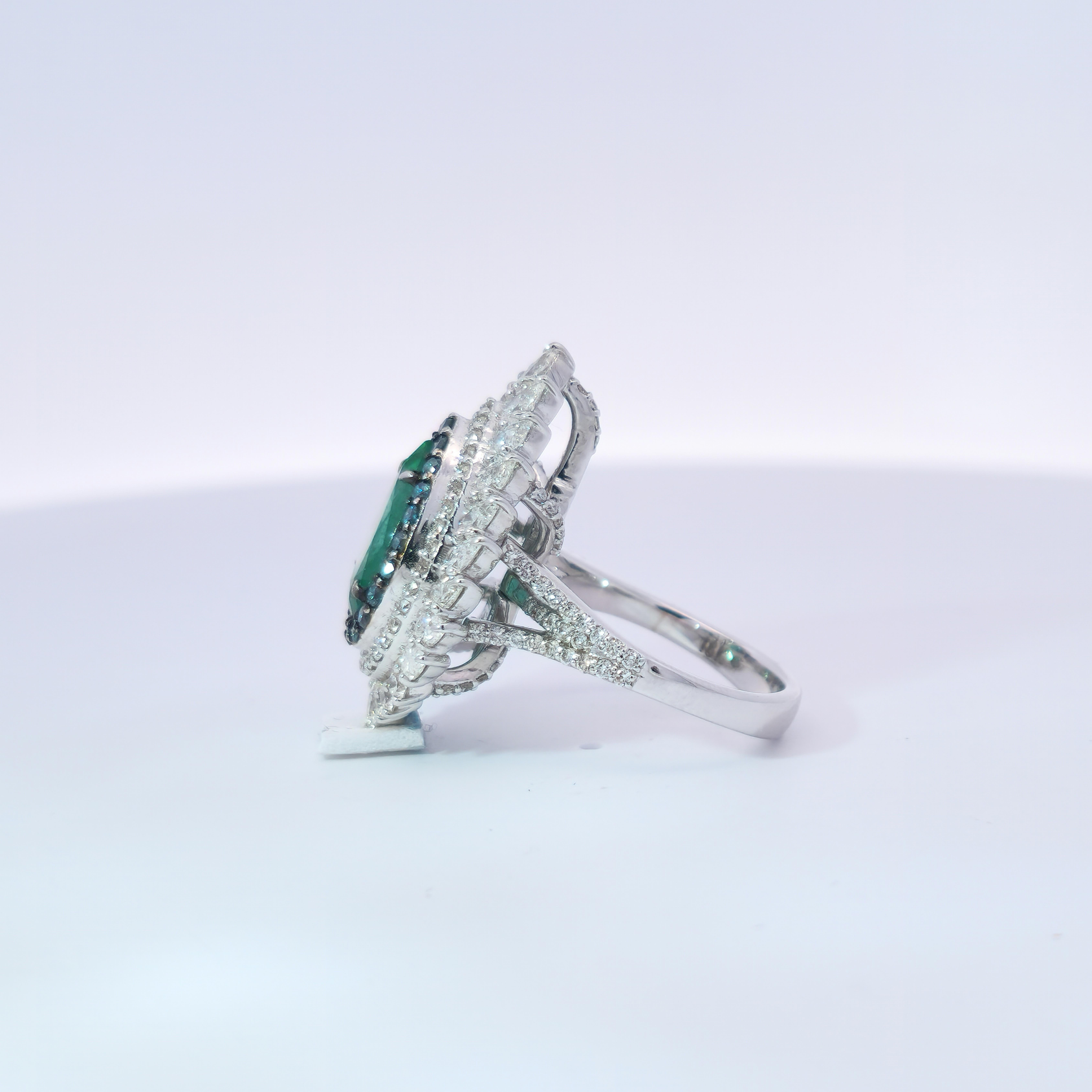 Rehaussez votre collection de bijoux avec cette extraordinaire bague en émeraude en forme de poire, véritable incarnation du luxe et de l'art raffiné. En son cœur se trouve une vibrante émeraude de 2,61 carats, dont la teinte vert profond dégage une
