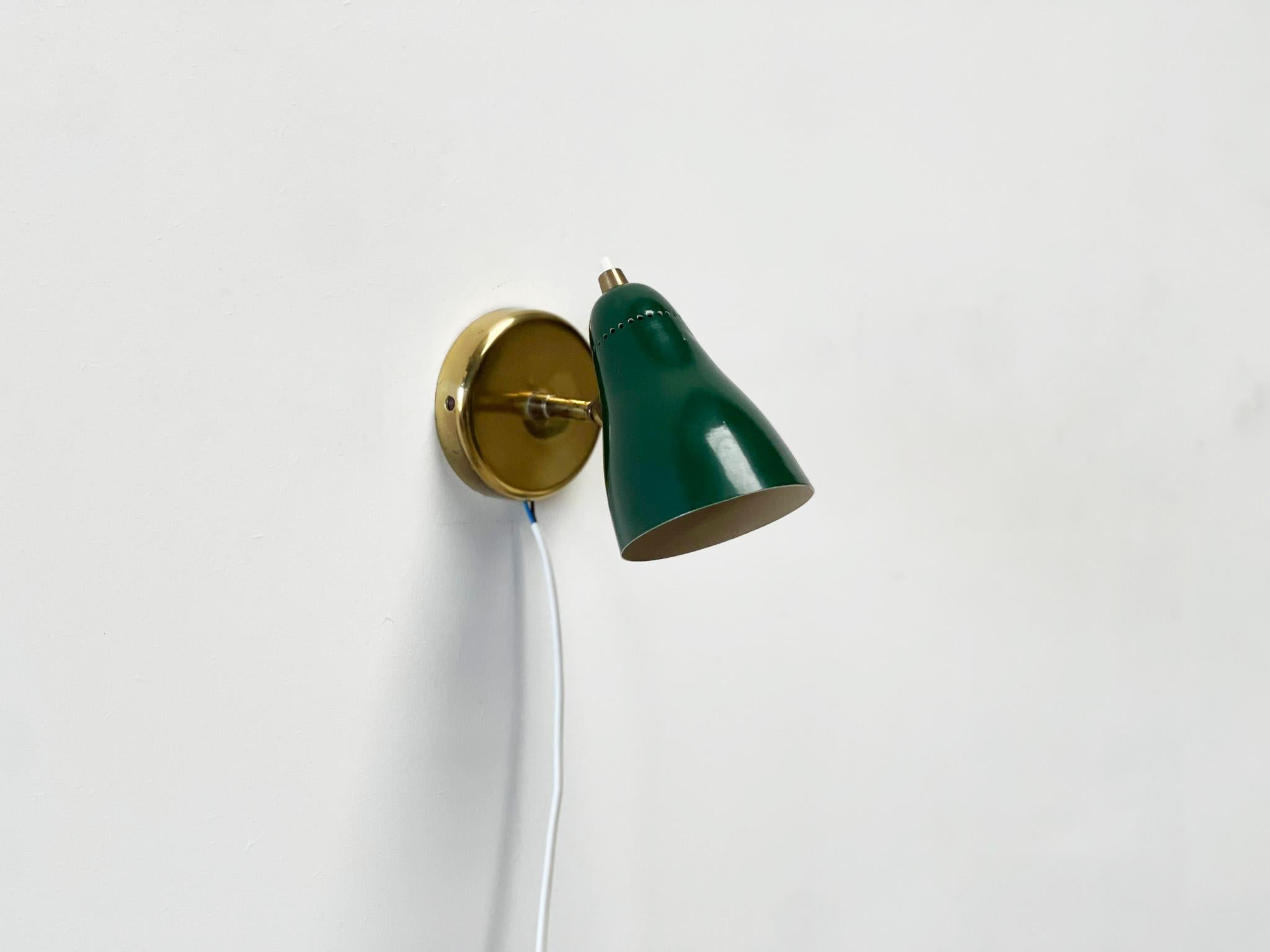 Green Perforated Wall Lamp by Jacques Biny
Nice wall lamp designed by Jacques Biny. These are typical elegant lamps from the 50's. This one has a very nice enamel shade with brass wall bracket. 

This is a very good example of the typical French